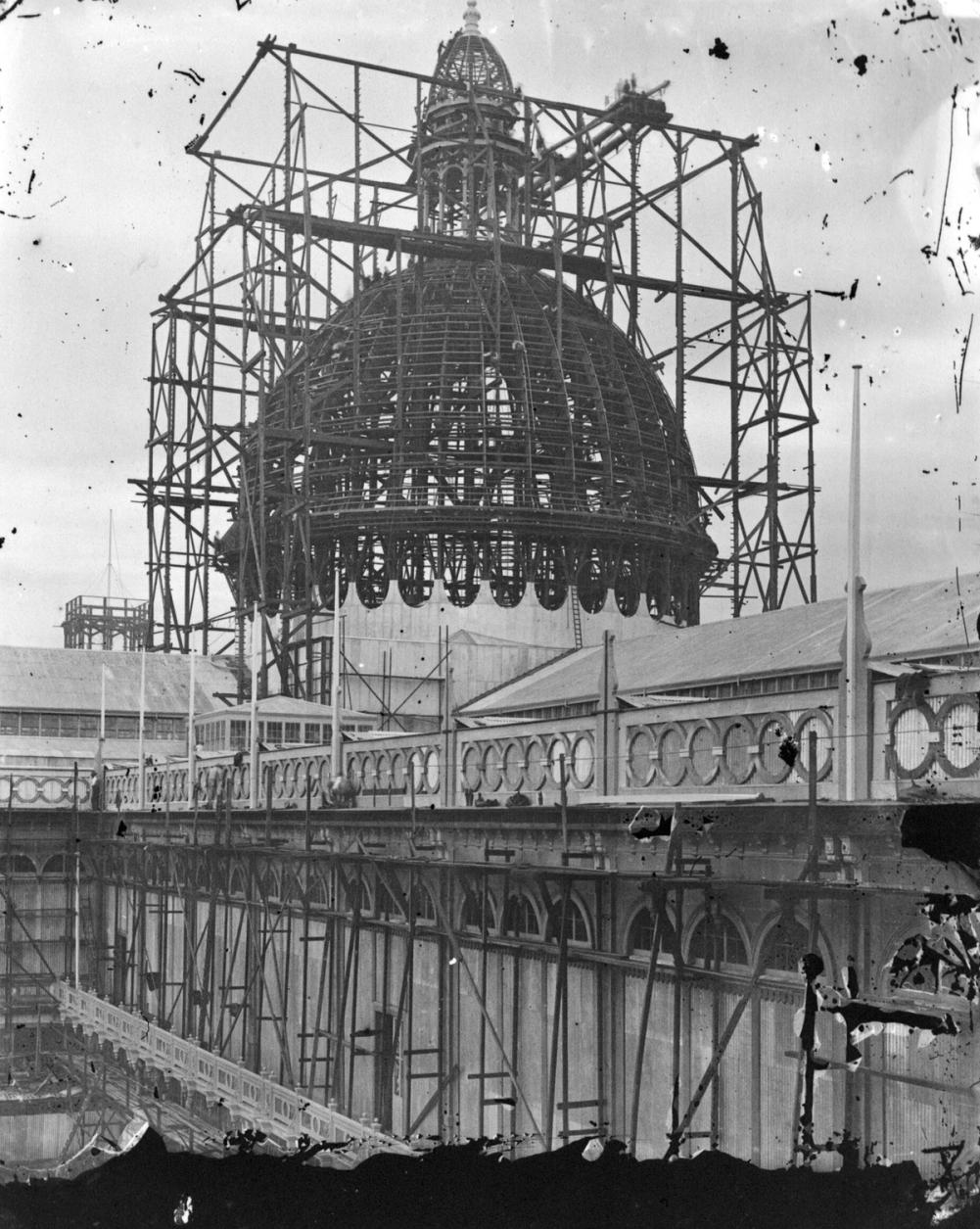 Black and white image of the a wooden dome structure being constructed