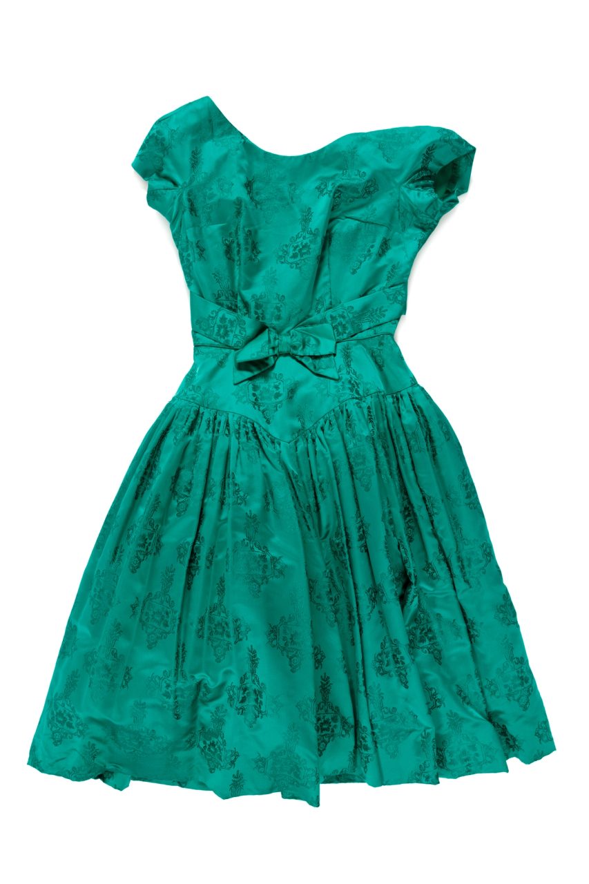 Emerald green brocaded silk cocktail dress with a round neckline at front.