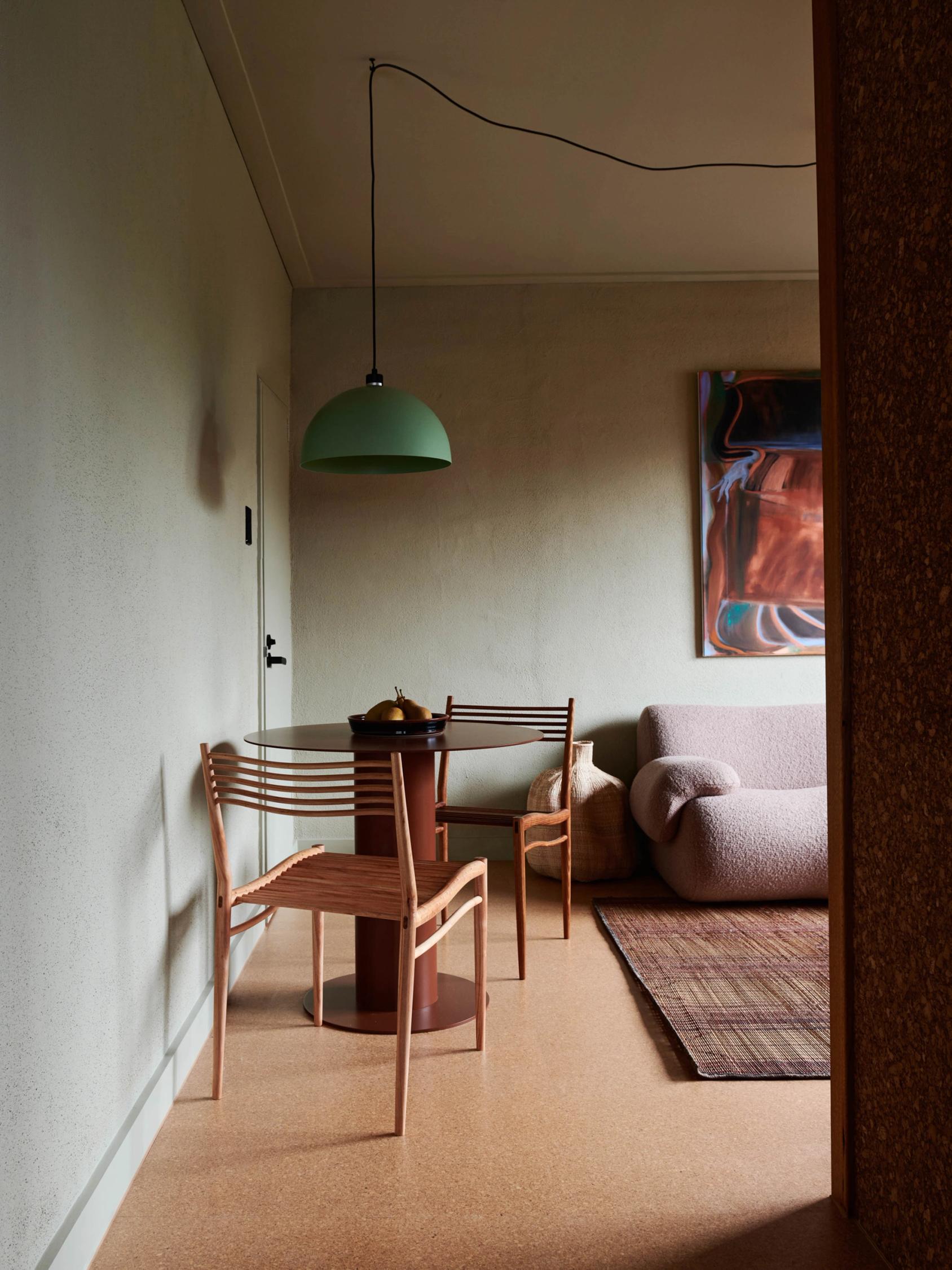 Dining set of chairs with table, and couch in the background.