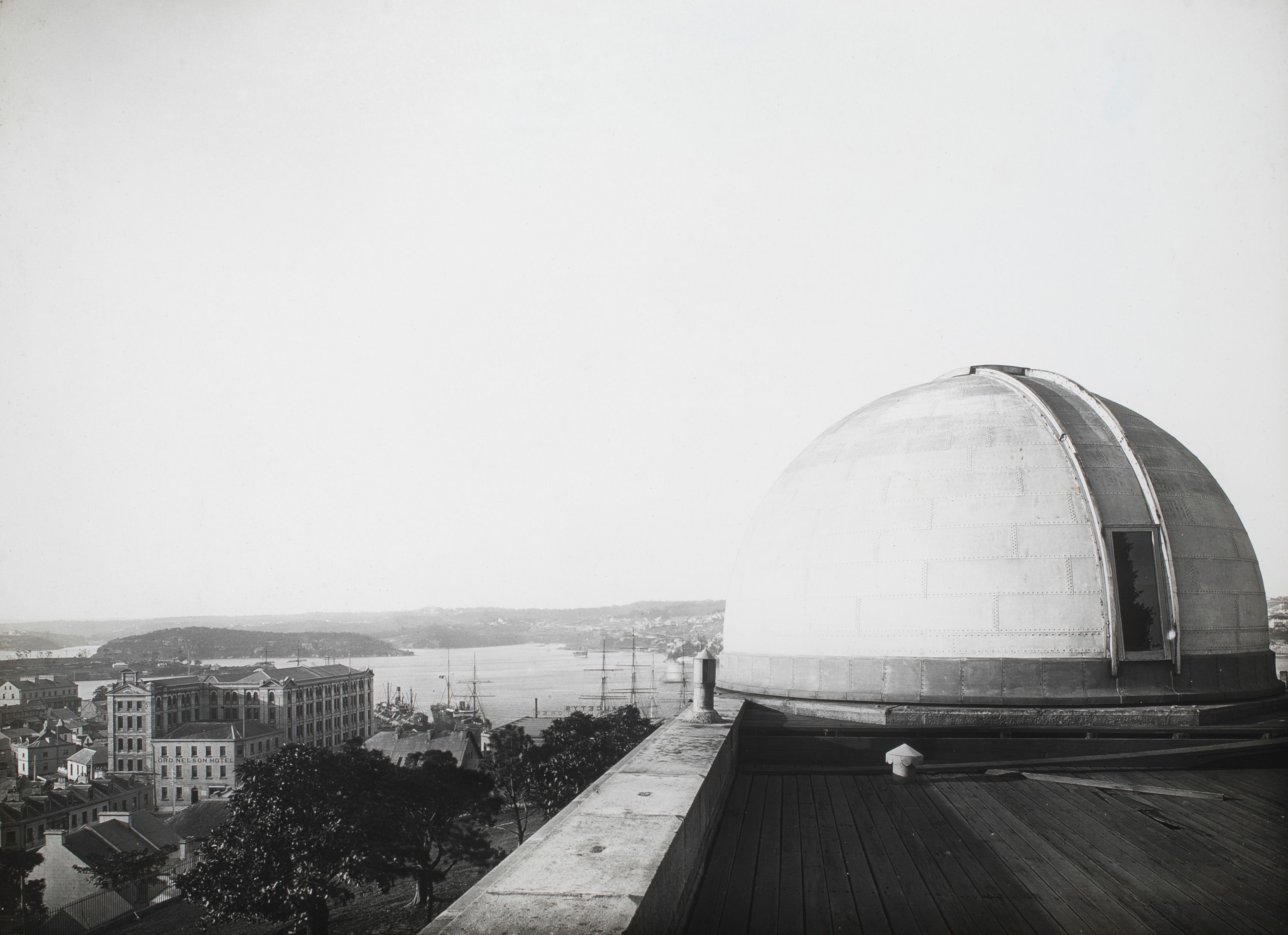 Observatory’s dome in the foreground right, and a view of Sydney Harbour to the rear