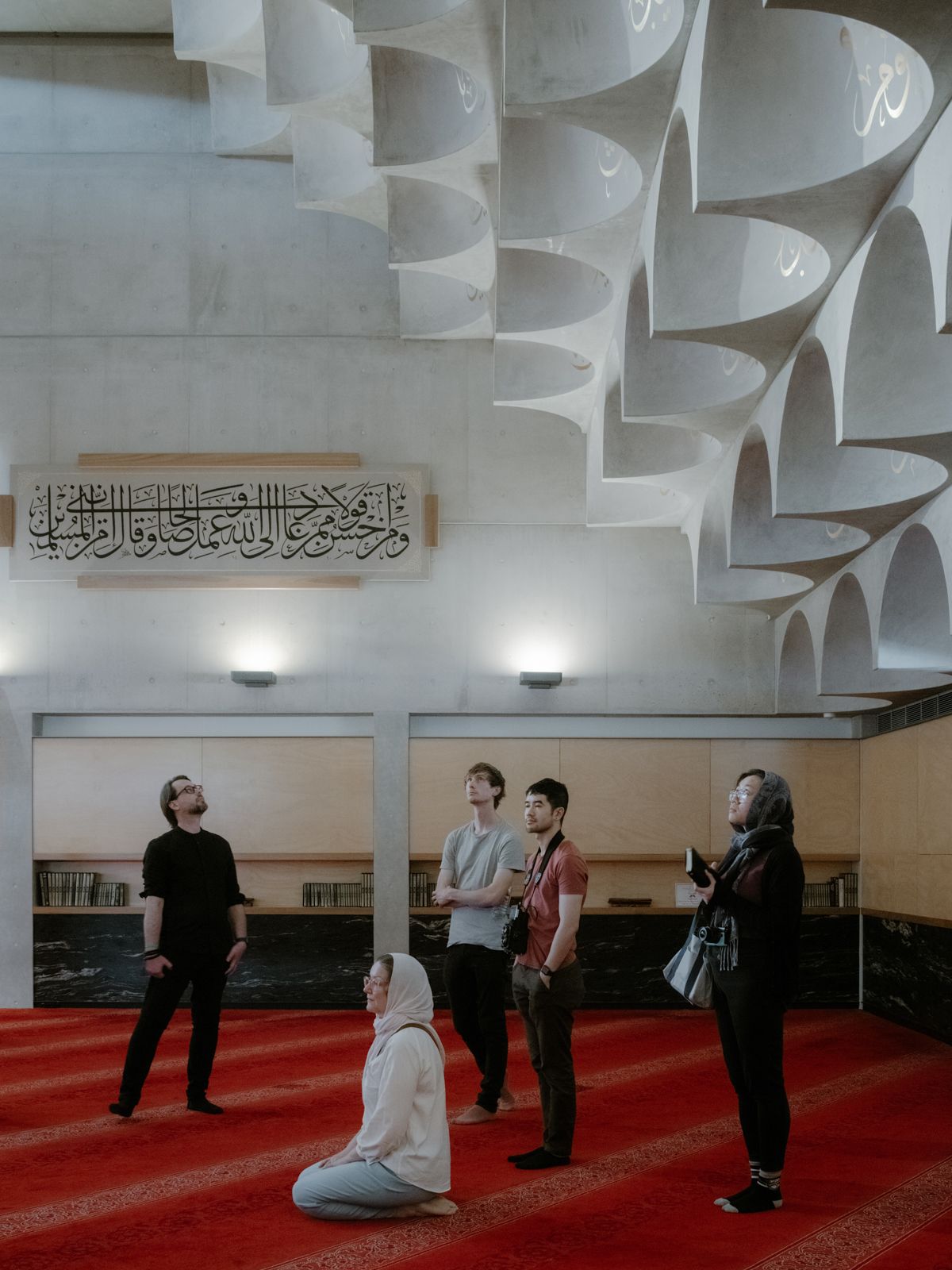 Figures taking in the beauty of the Mosque from inside