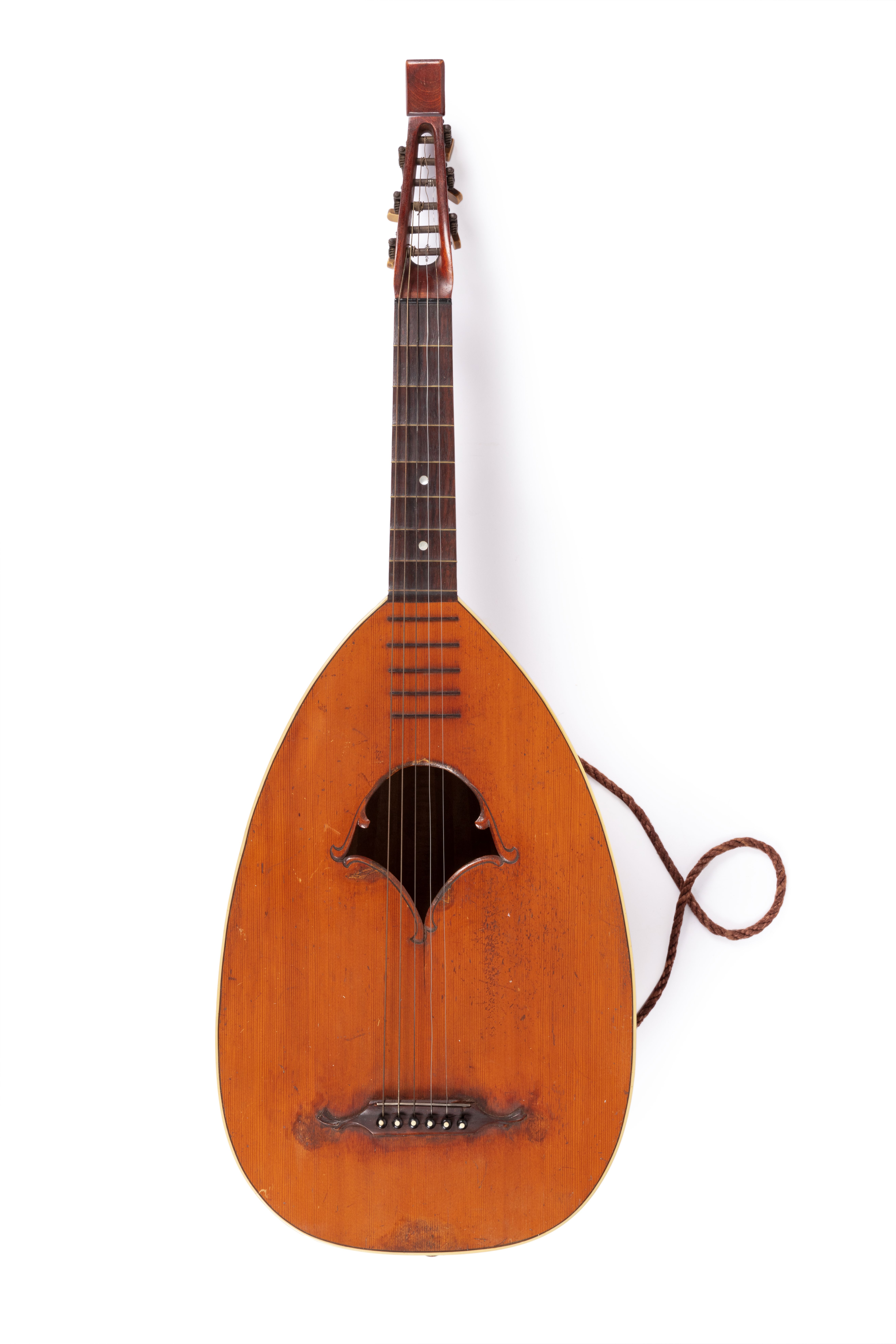 Pear-shaped back made up of 11 ribs; two-piece [cedar] soundboard with unusually-shaped soundhole and ivory purfling; very worn wooden saddle with metal bridge; black wooden bridge pins with ivory inlay; guitar-like hardwood neck meets body at 8th fret; rosewood fingerboard; brass frets extend onto soundboard; two mother-of-pearl fret dots; curved headstock with flat finial and six metal machineheads with yellowish knobs (one knob missing).