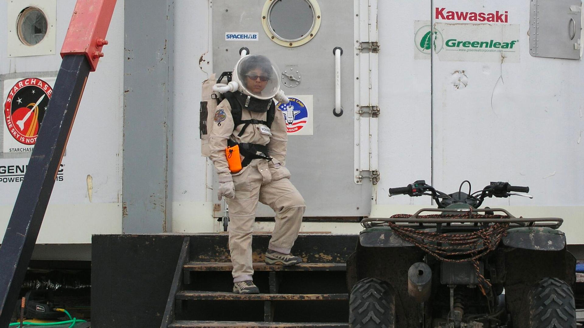 Woman standing on space station.