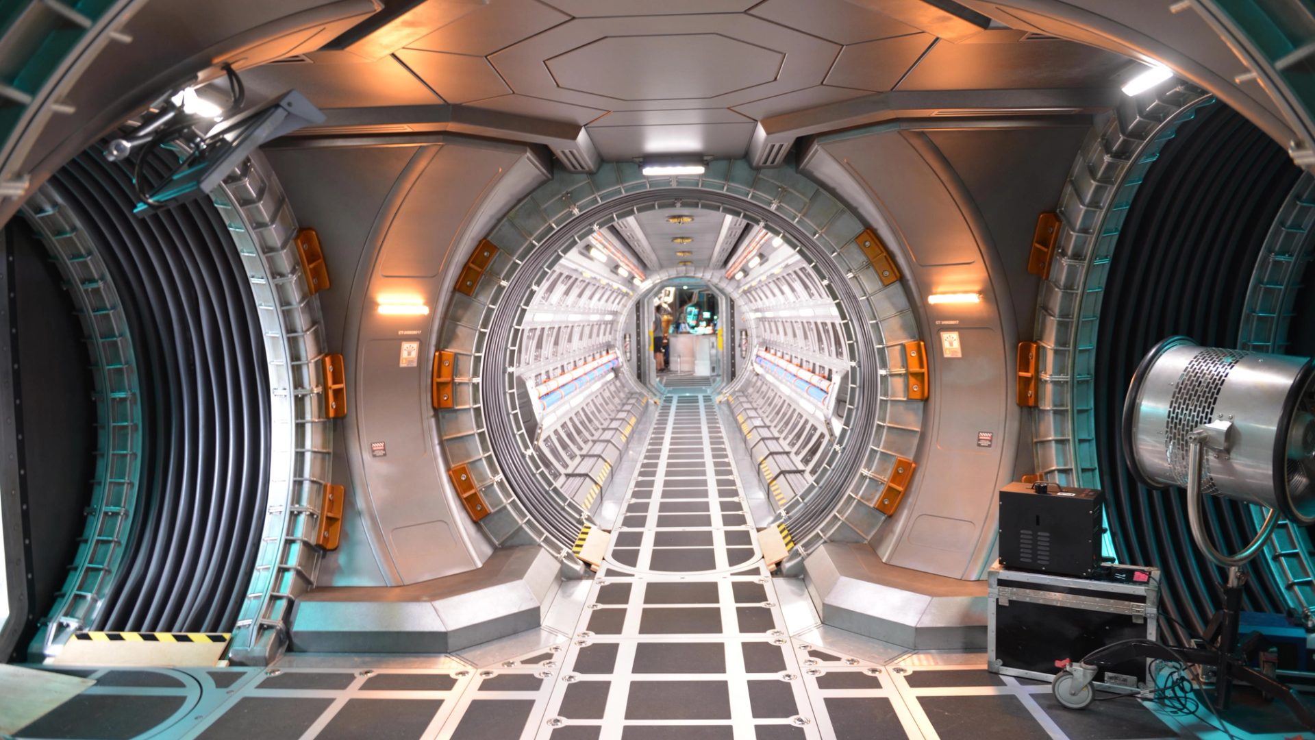 A film set depicting silver corridors from the interior of a spacecraft.