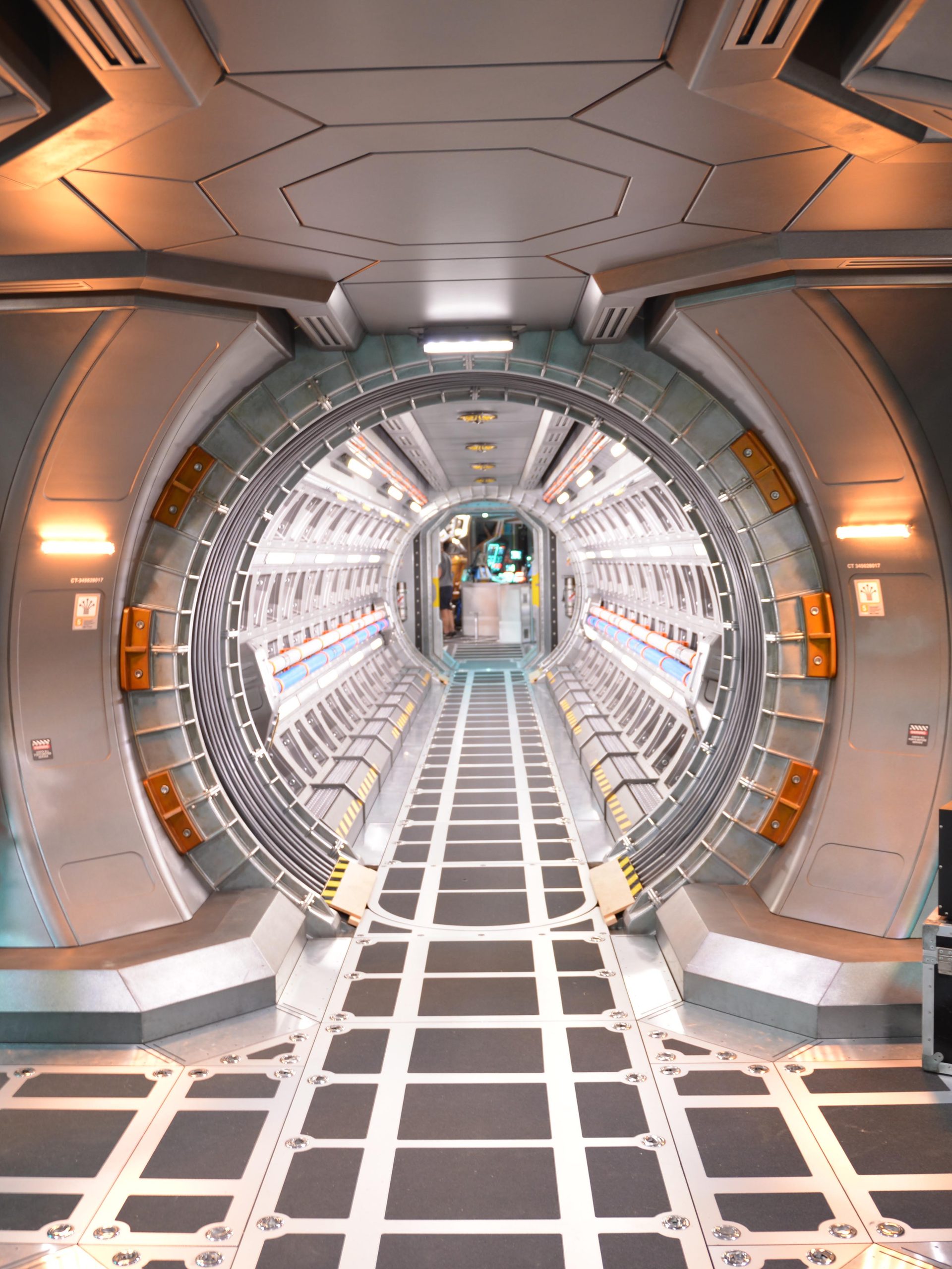 A film set depicting silver corridors from the interior of a spacecraft.