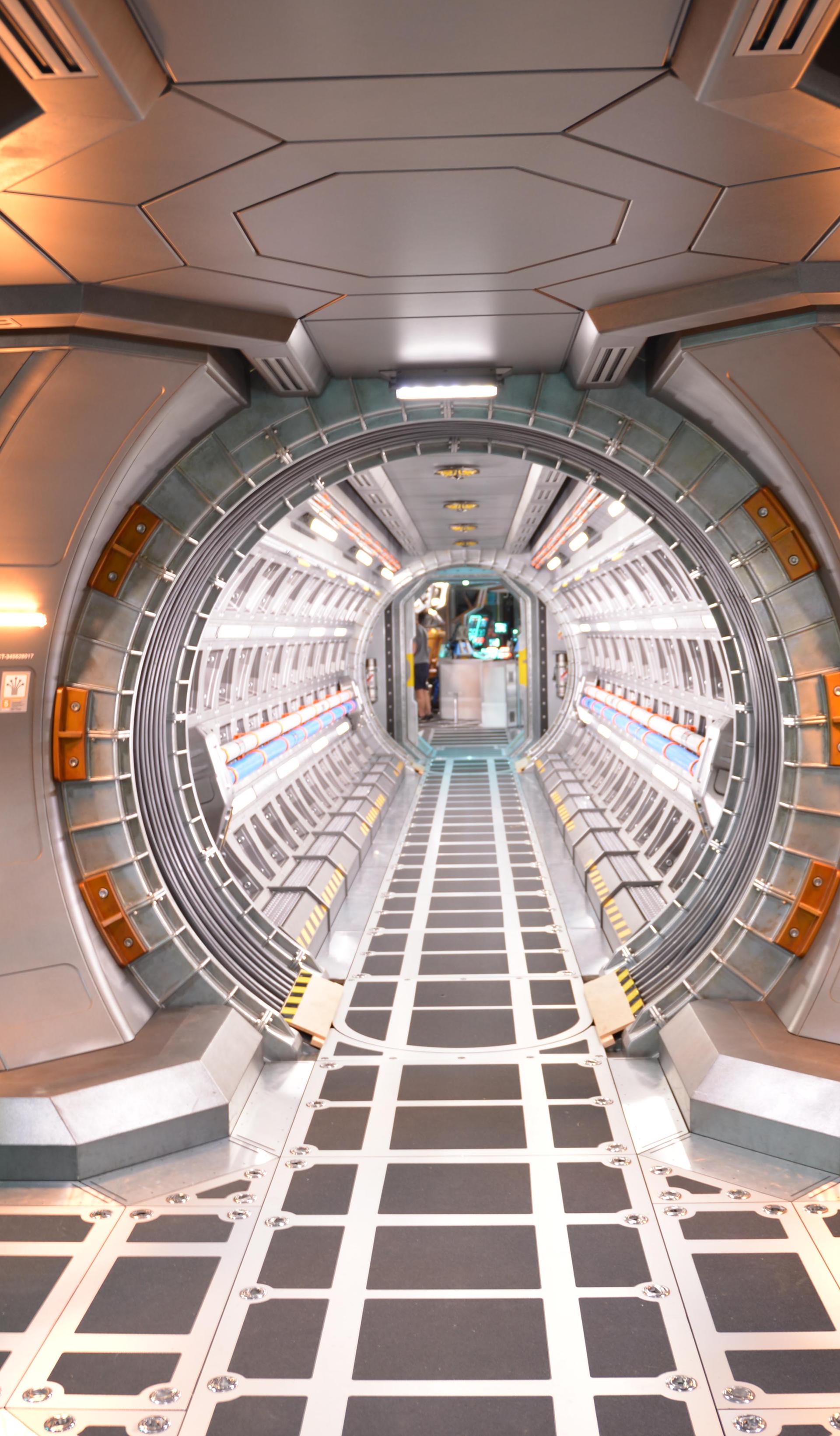 A film set depicting silver corridors from the interior of a spacecraft.
