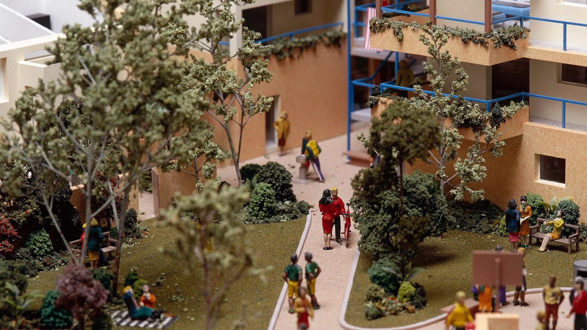A scale model depicting a residential area, showcasing people walking and enjoying the community environment
