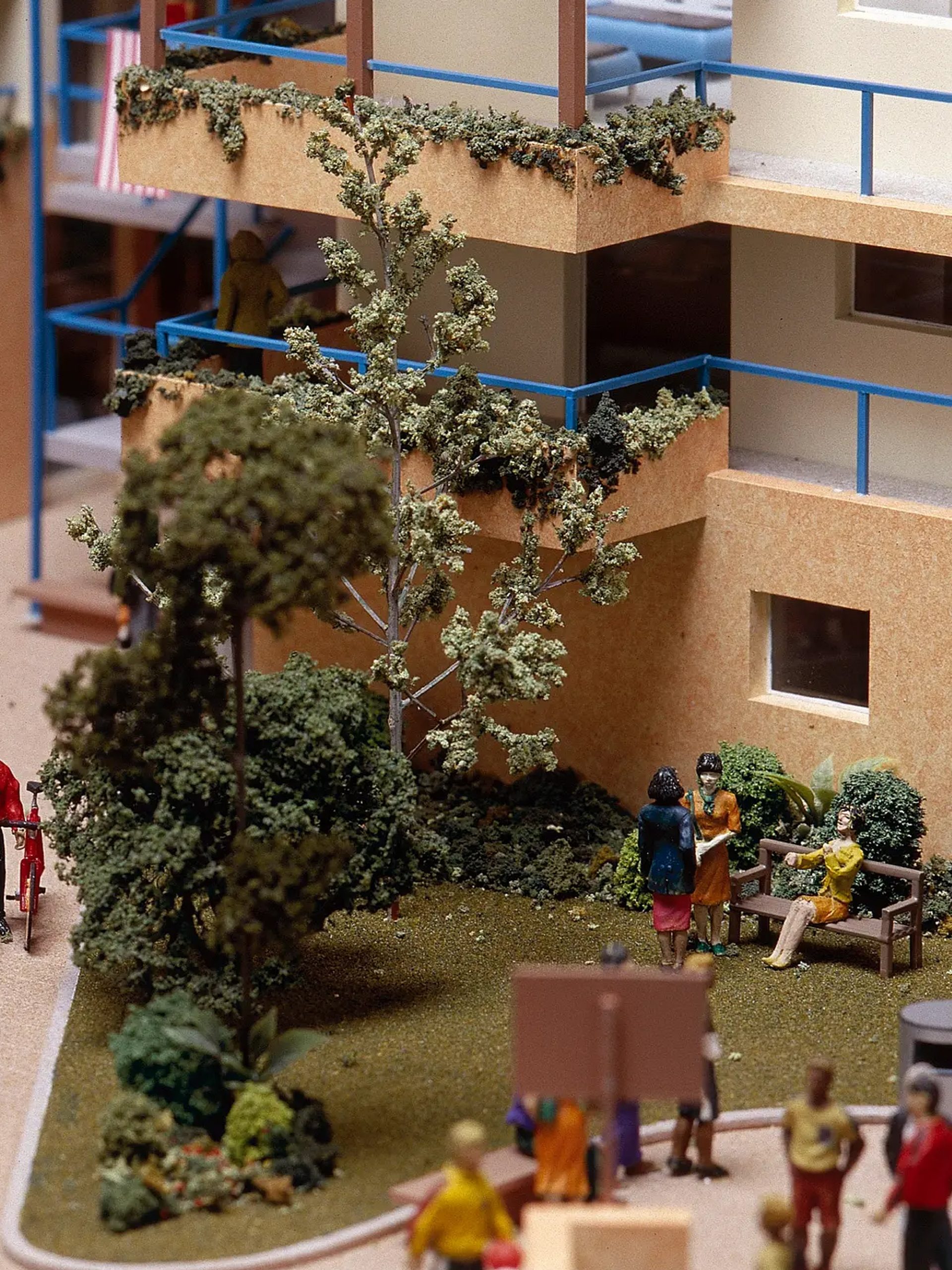 A scale model depicting a residential area, showcasing people walking and enjoying the community environment
