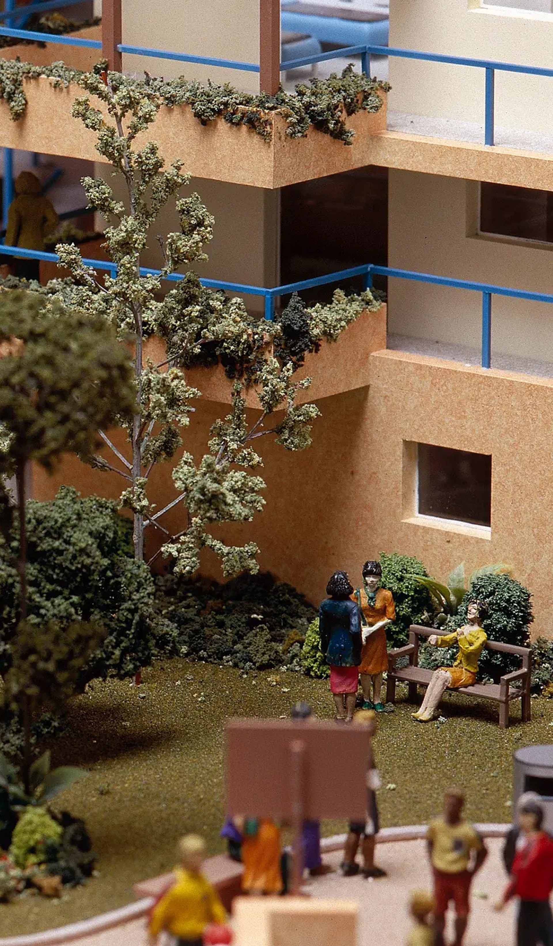 A scale model depicting a residential area, showcasing people walking and enjoying the community environment