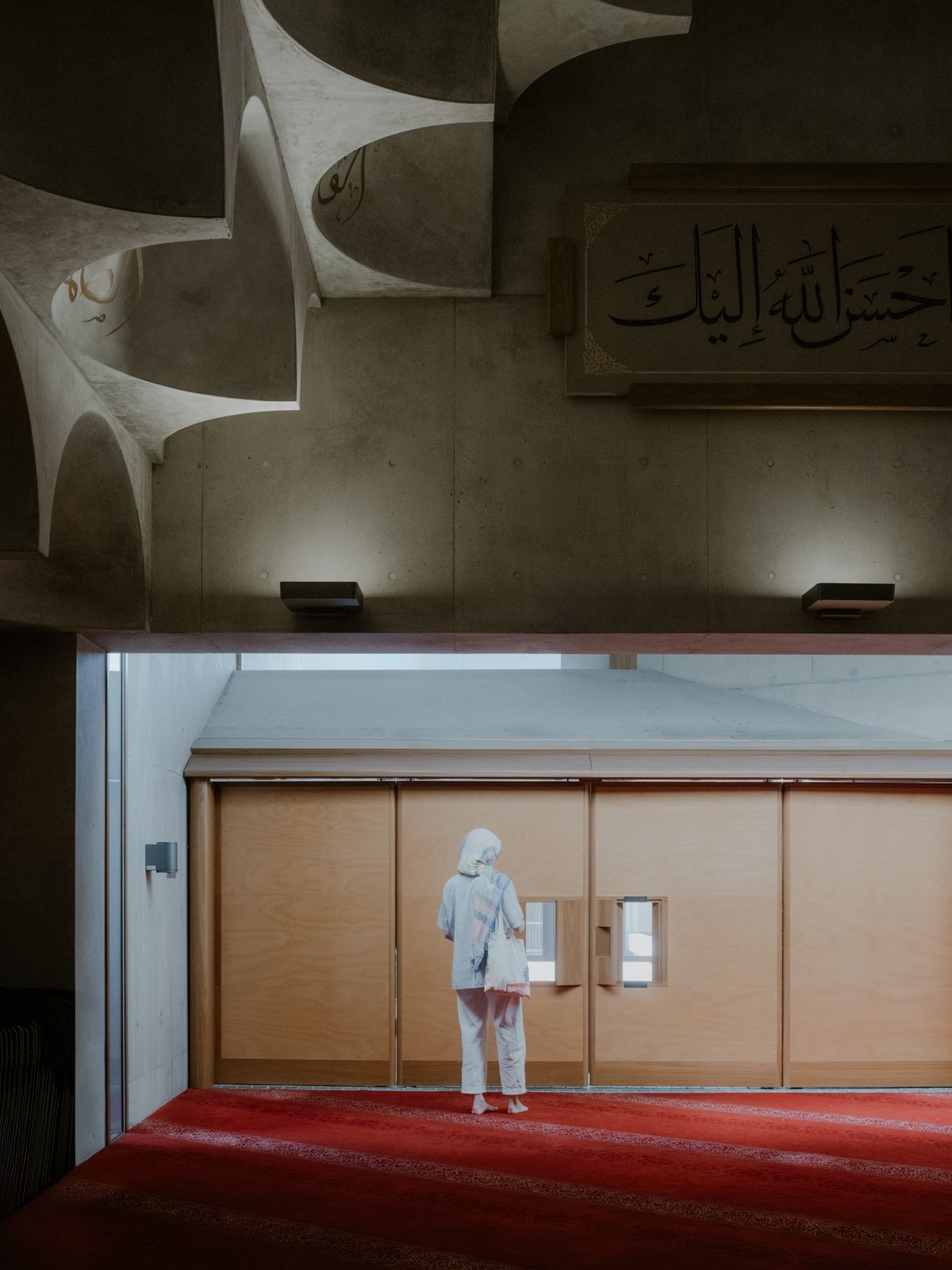 Figure walking towards a set of doors