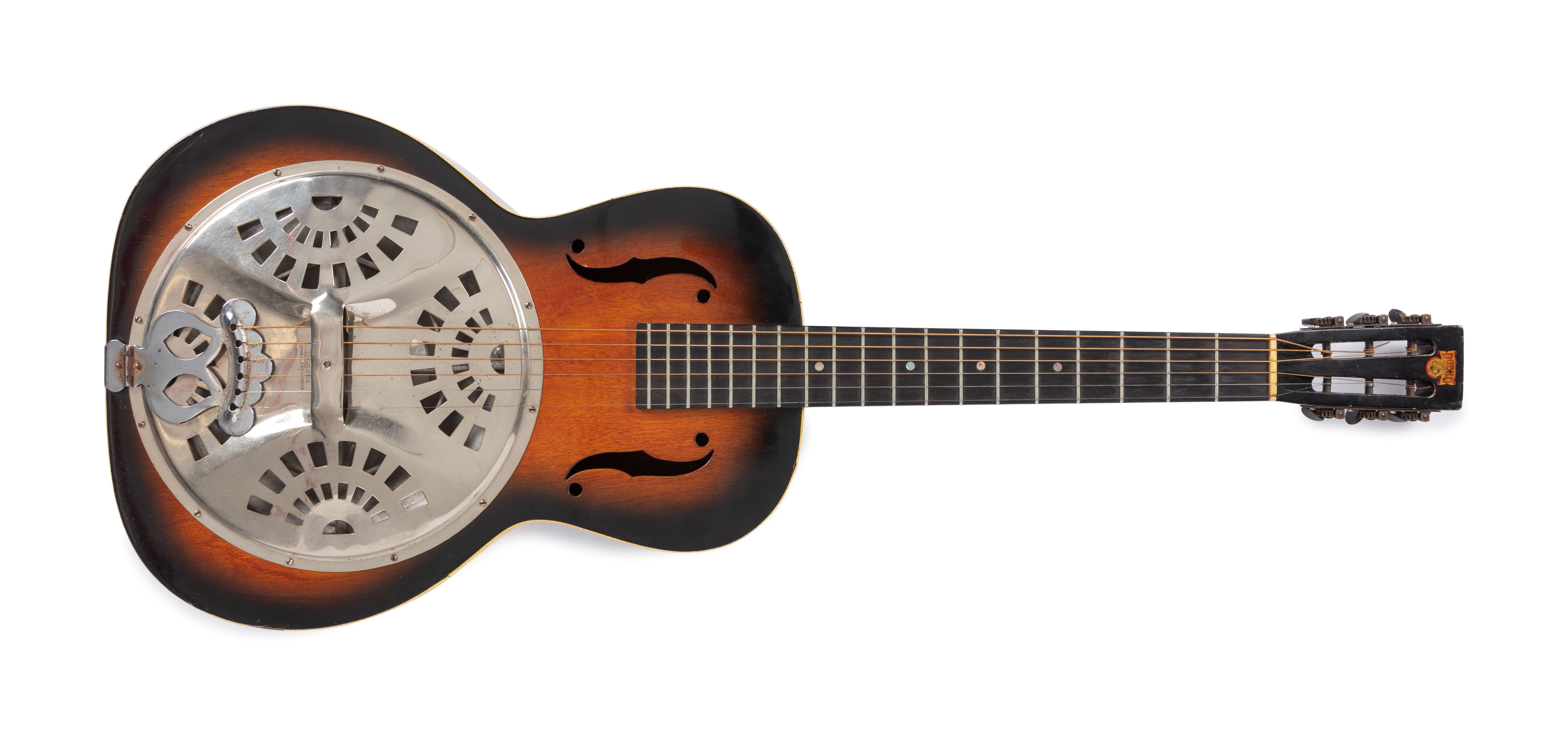 Sunburst varnished plywood body with aluminium resonator; celluloid binding front and back; 19 frets on stained rosewood fingerboard; six machineheads with black plastic pegs on a square topped slotted headstock carrying the Dobro transfer. No serial number on head. Eight armed spider bridge support. Standard coverplate pattern of 4 semi circular groups of rectangular holes with 17 holes in each group.