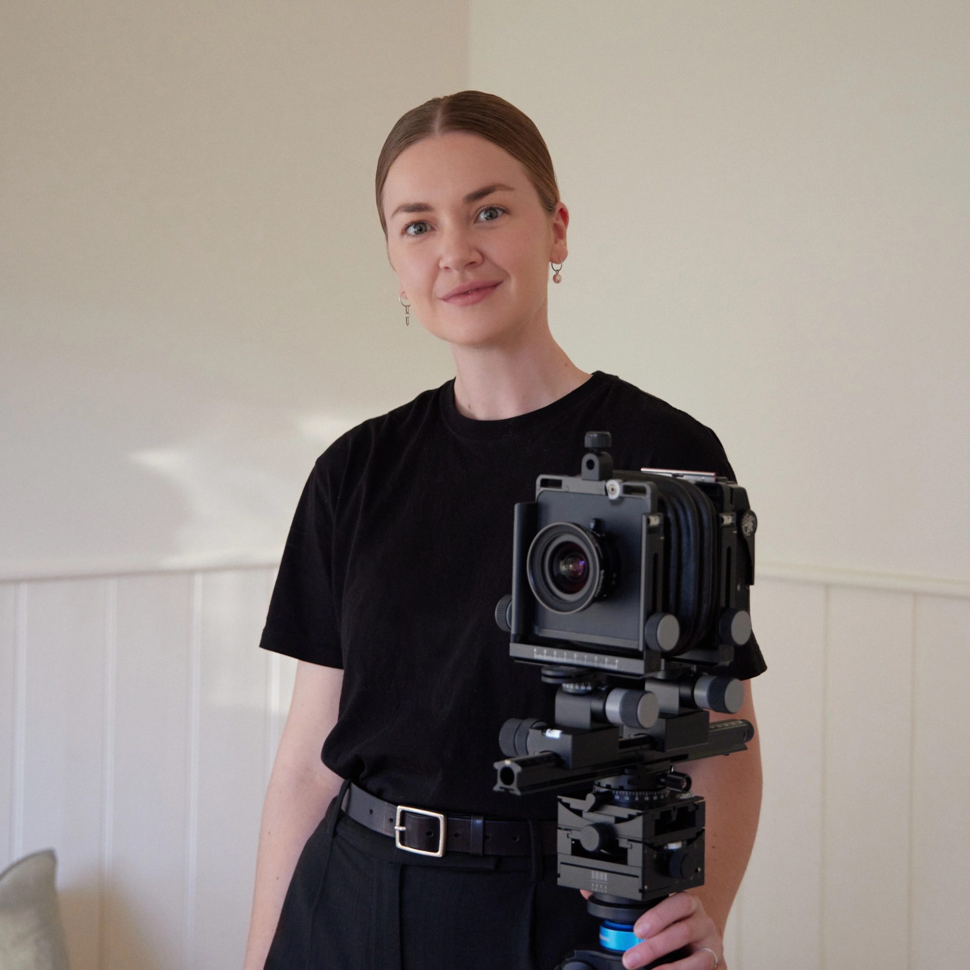 Tasha Tylee portrait with camera on tripod.