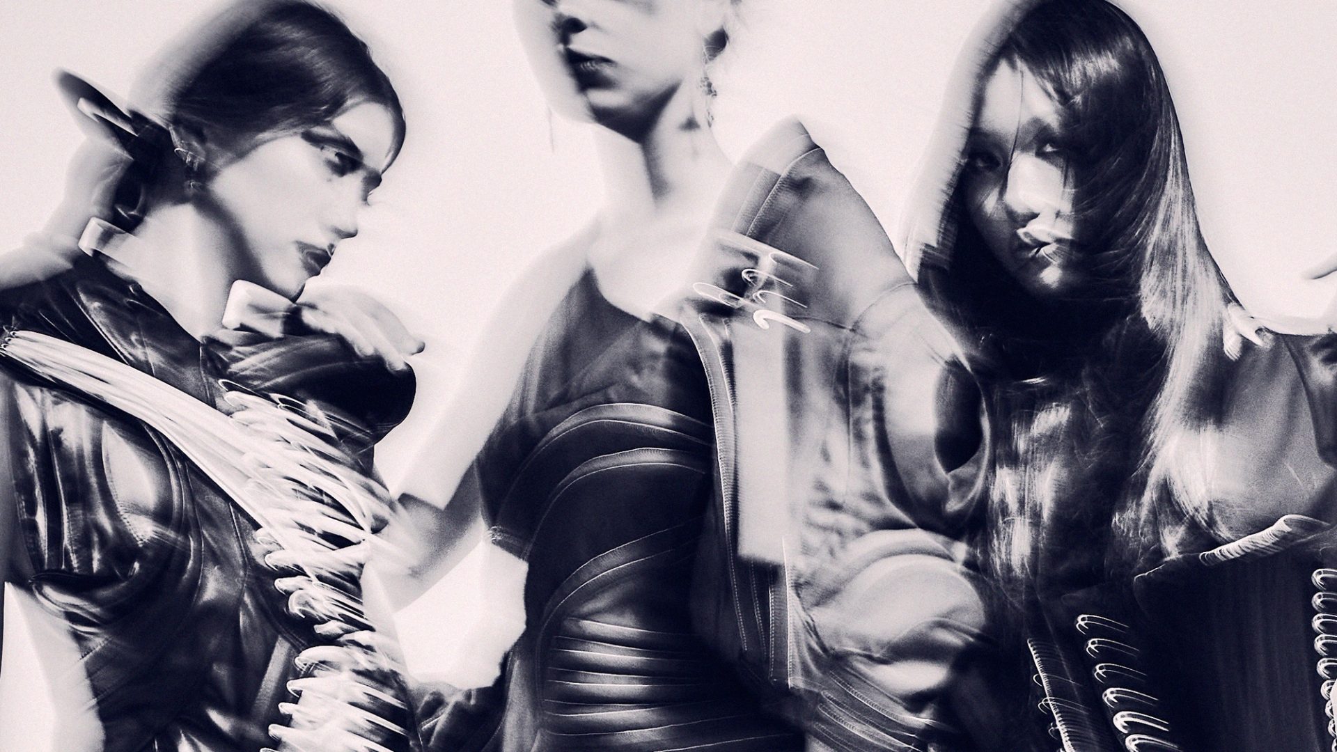 An abstract and hazy monochromatic image of three models.