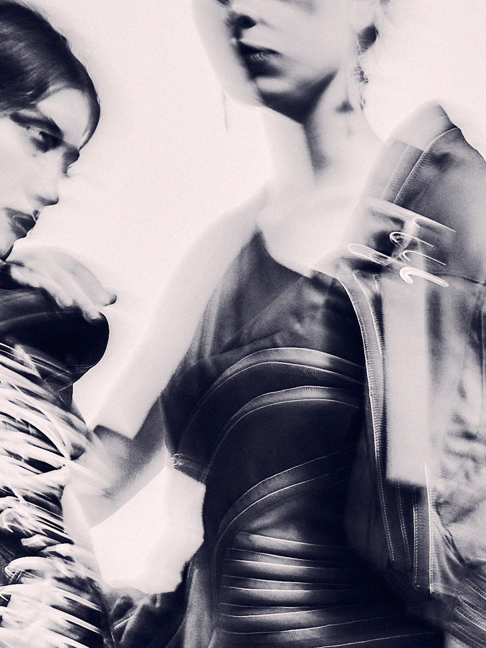 An abstract and hazy monochromatic image of three models.