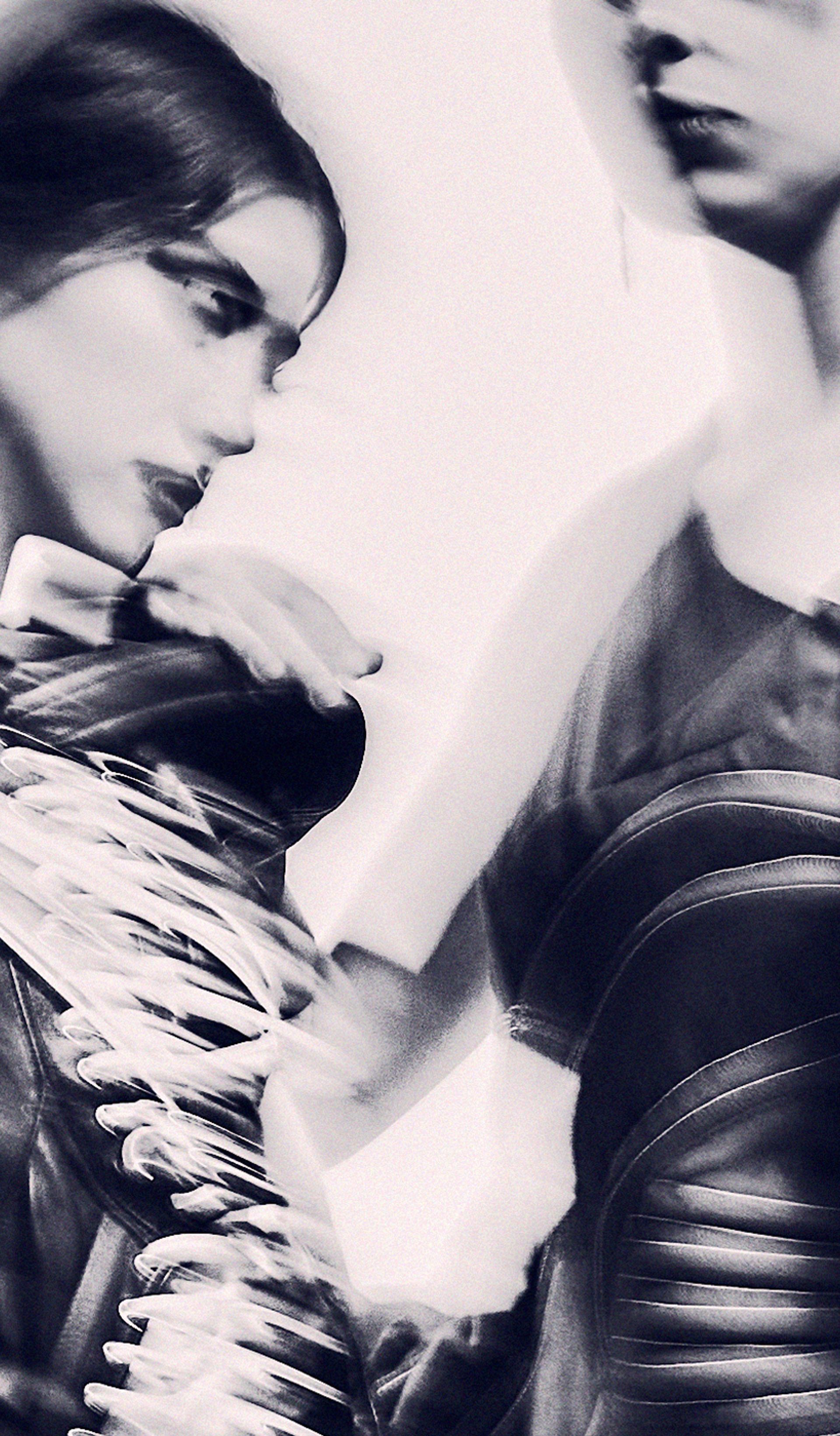 An abstract and hazy monochromatic image of three models.