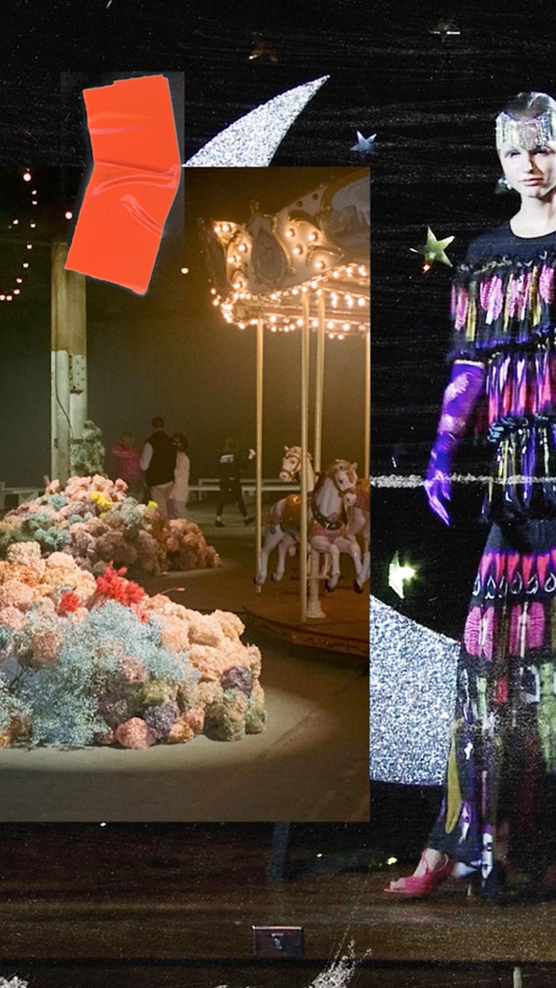 A model stands on the runway during the Australian Fashion Week 2022 Romance Was Born runway show. They wear a colourful floor length dress.