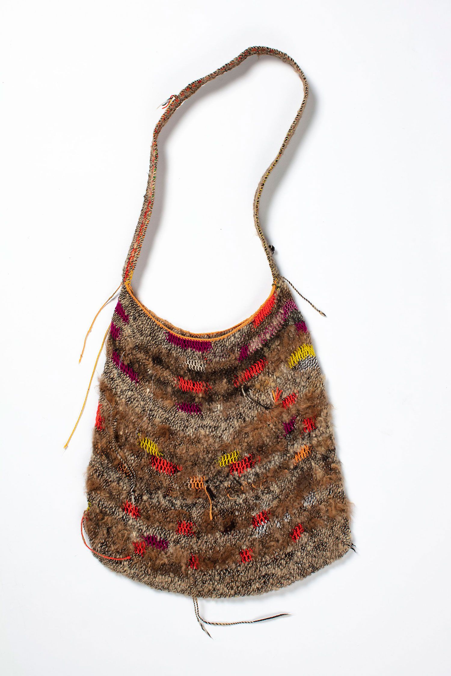 A hand woven polyester fibre and wool bag featuring colourful patterns.