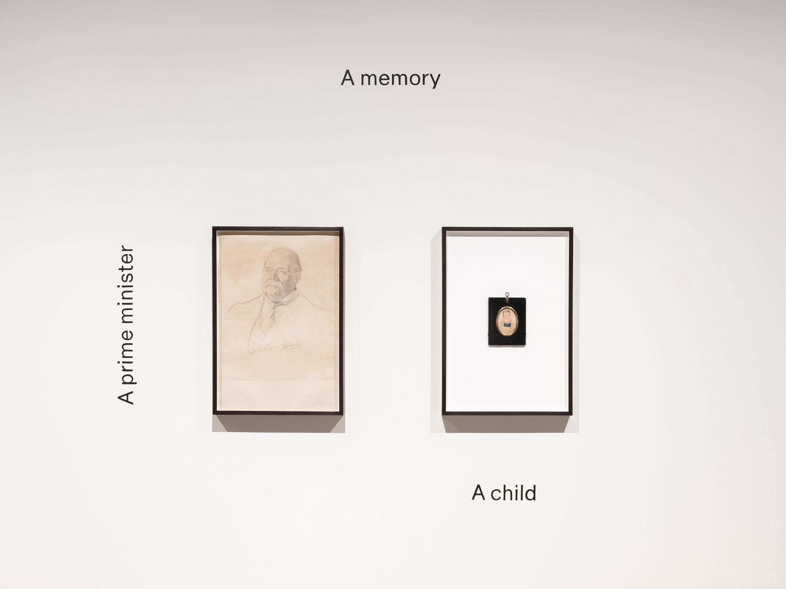 Two frames on a white wall featuring a drawing of male figure and a child