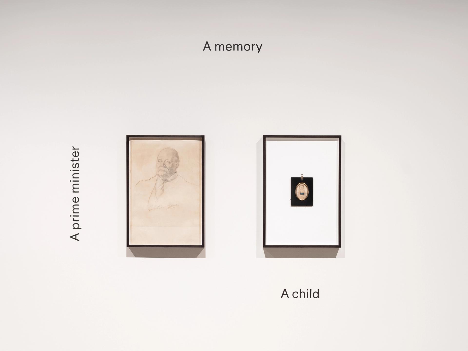 Two frames on a white wall featuring a drawing of male figure and a child