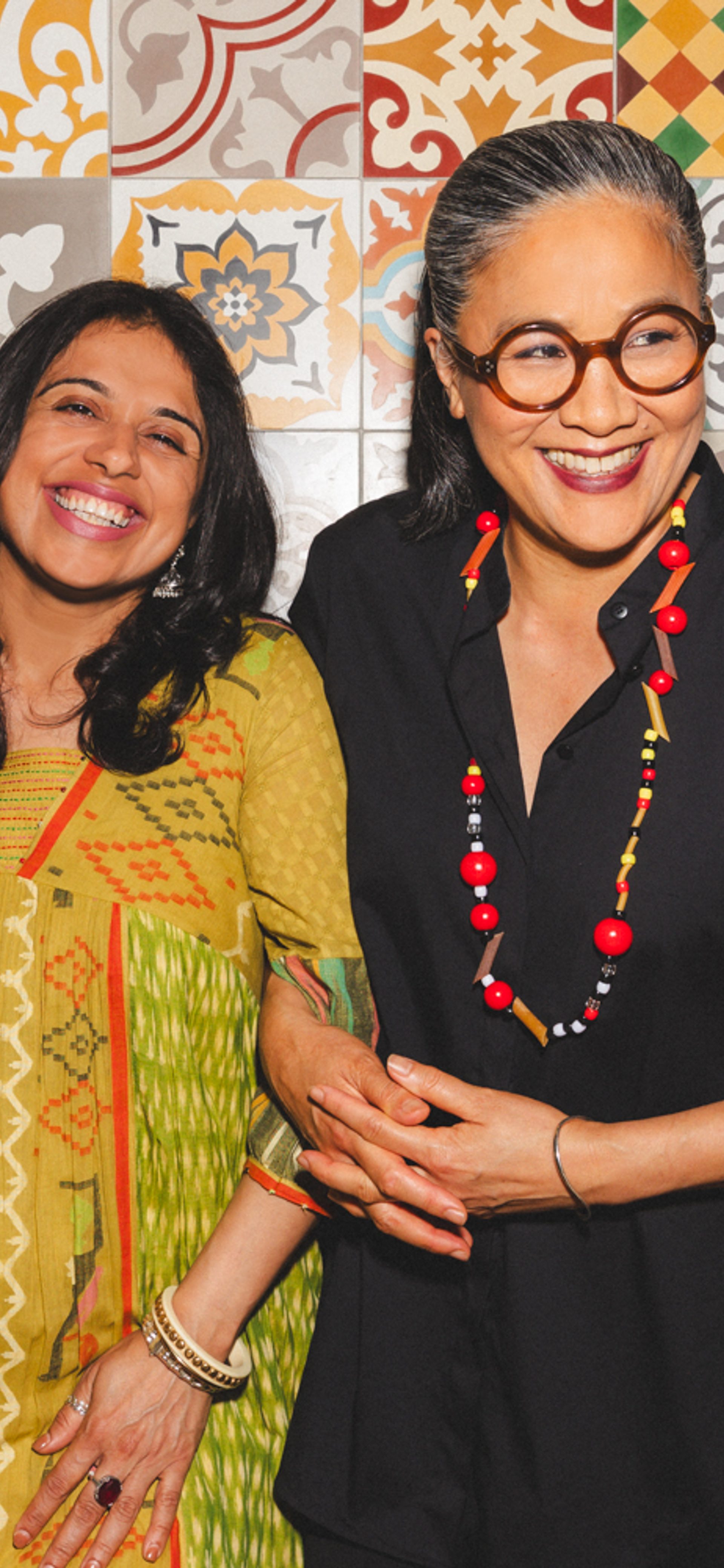 Two figures smiling for the camera.