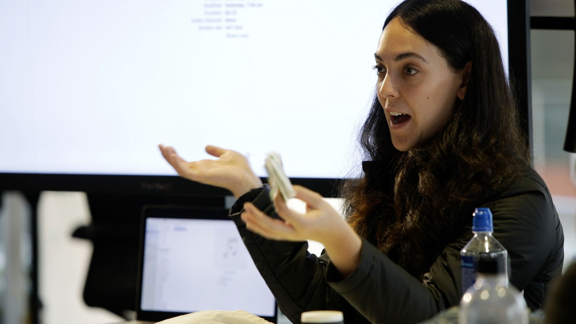 Creative Studio facilitator Gilliam Kayrooz gestures towards a screen