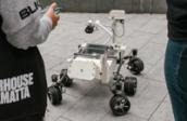 Mars Rover robot surrounded by kids