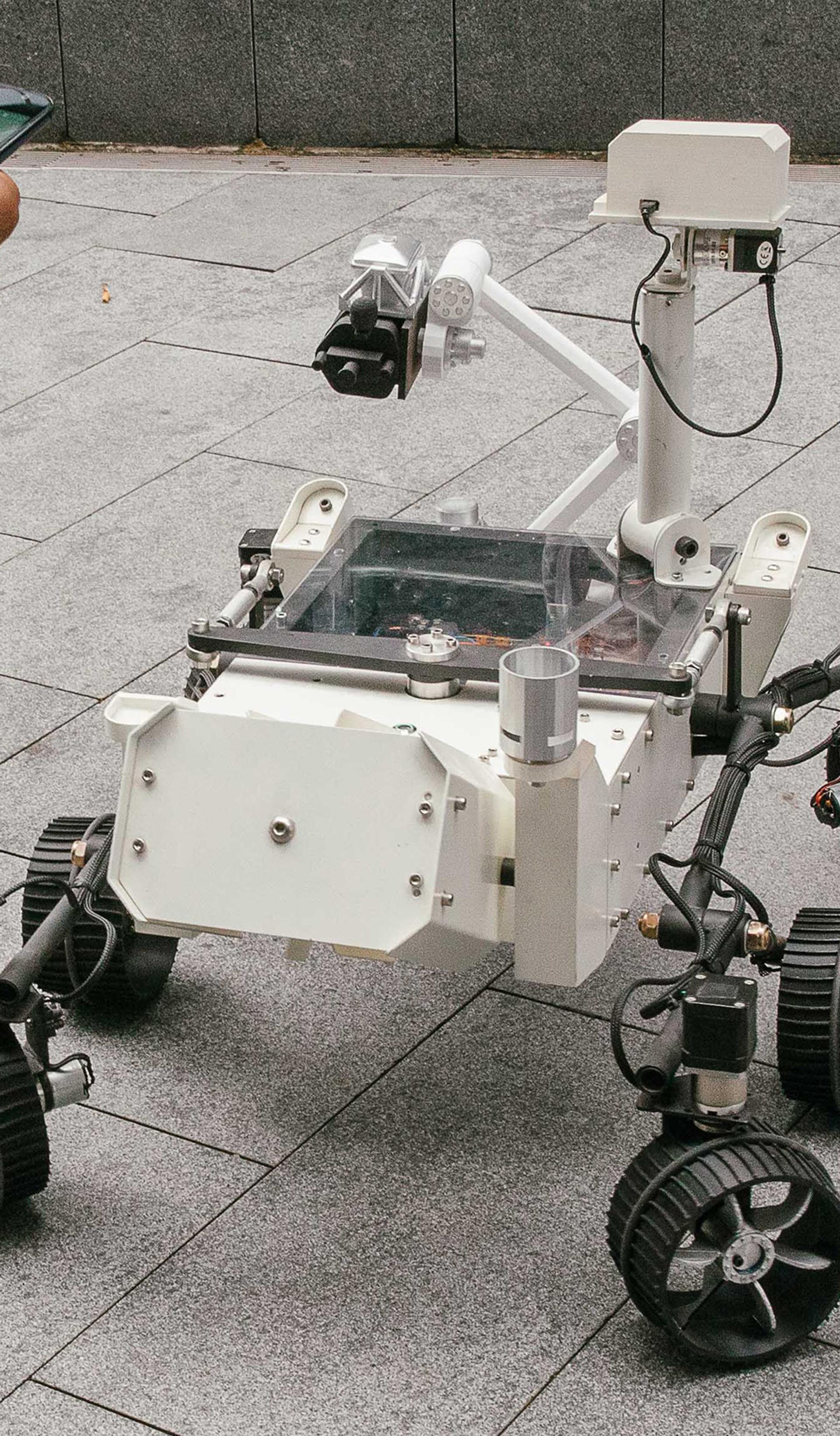 Mars Rover robot surrounded by kids.