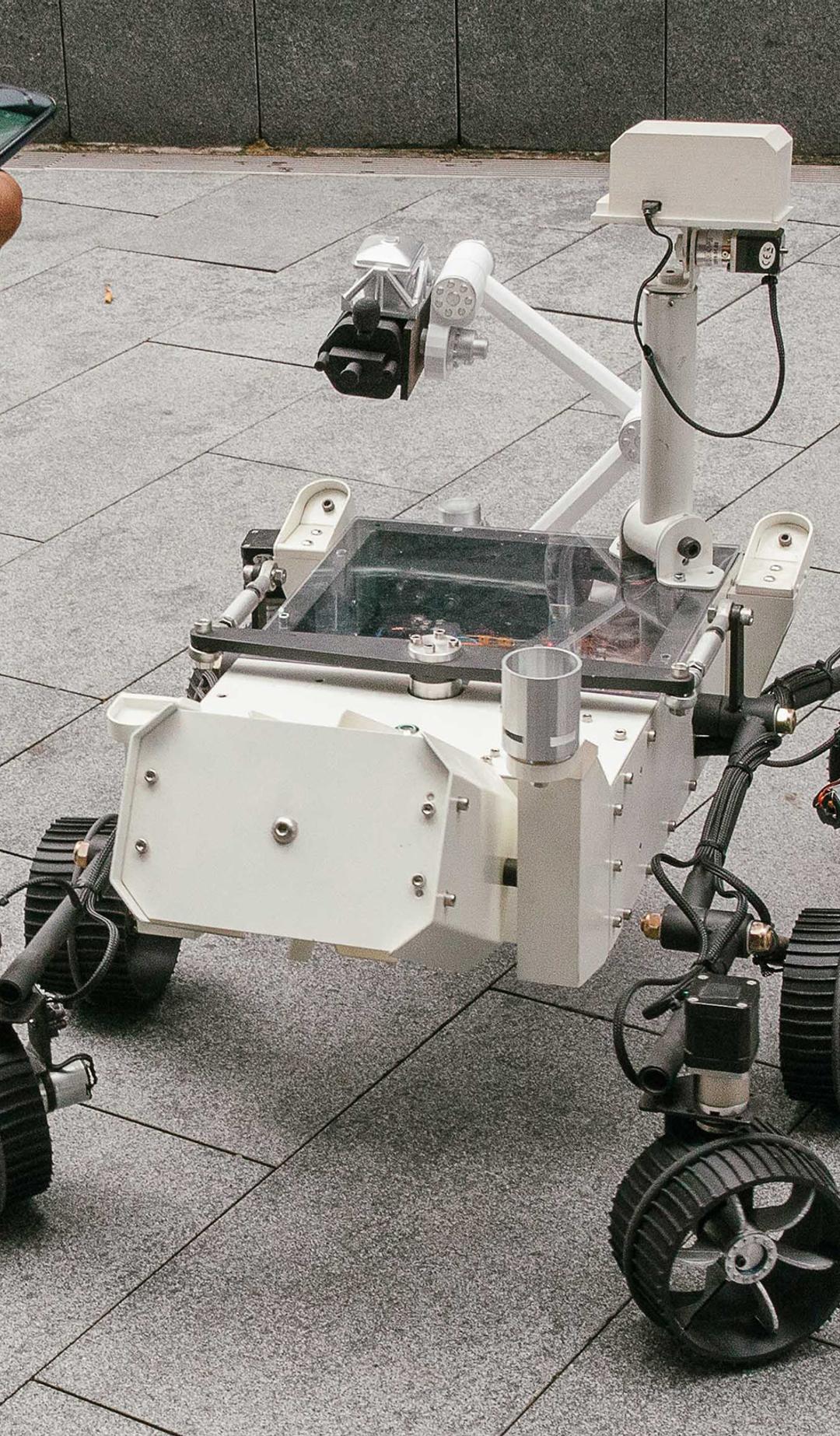 Mars Rover robot surrounded by kids.