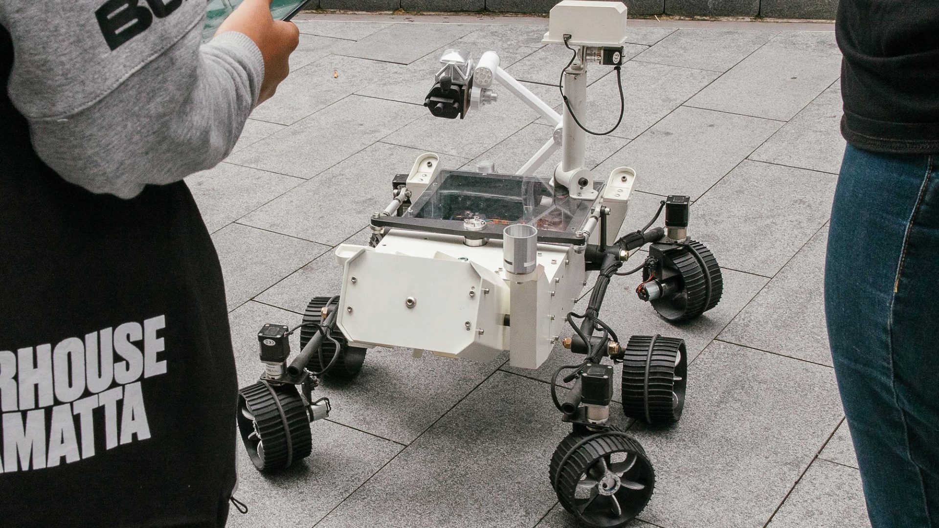 Mars Rover robot surrounded by kids