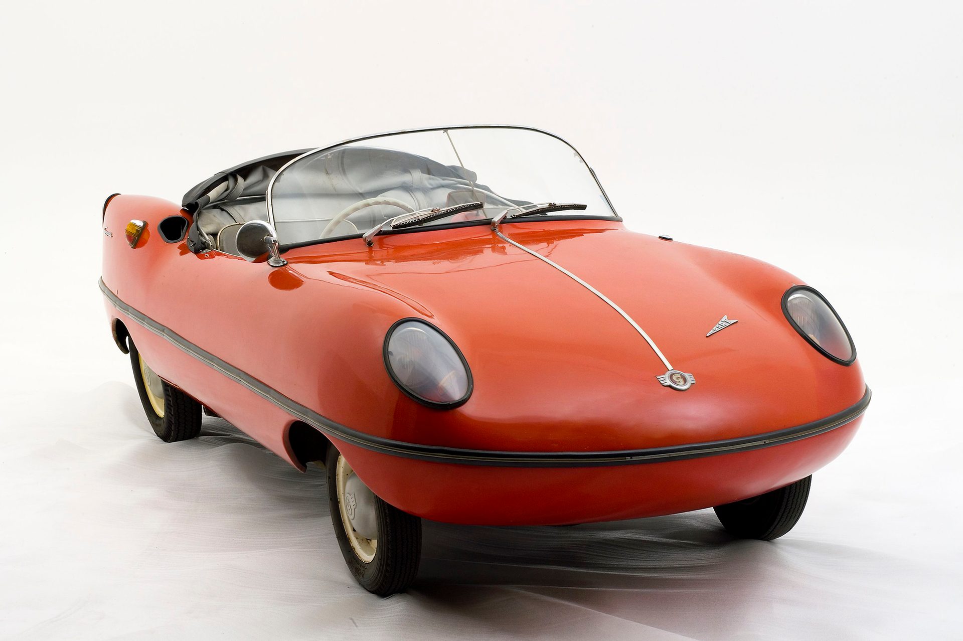 Open two seat, full size mini car with red painted fibreglass boy on a German built body and mechanics.