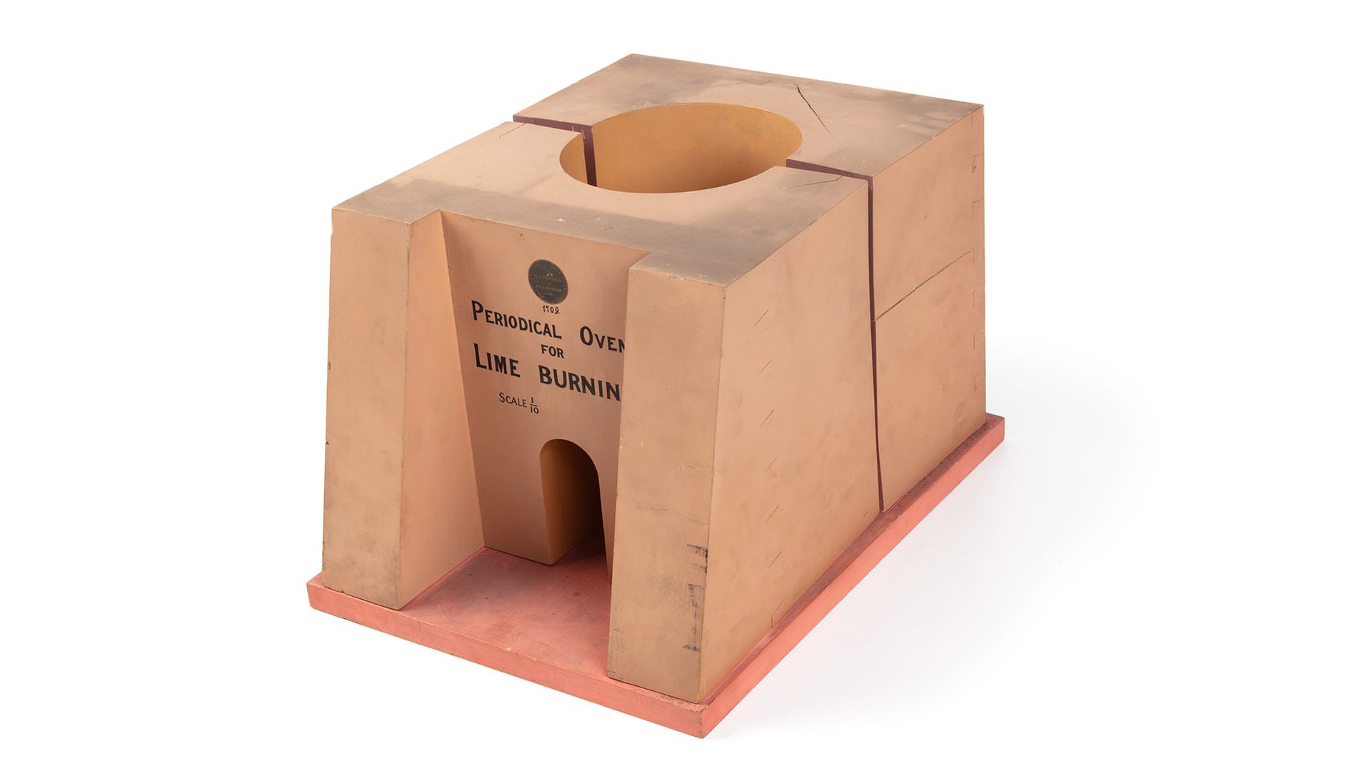 A model of a lime kiln or limestone burning furnace made from timber and metal. The front of the model reads ‘Periodical Oven For Lime Burning. Scale 1/10’.