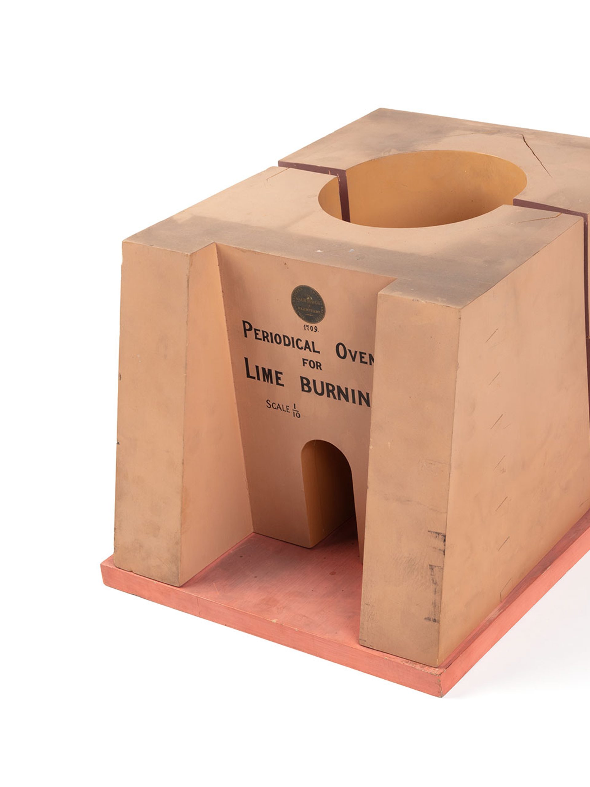 A model of a lime kiln or limestone burning furnace made from timber and metal. The front of the model reads ‘Periodical Oven For Lime Burning. Scale 1/10’.