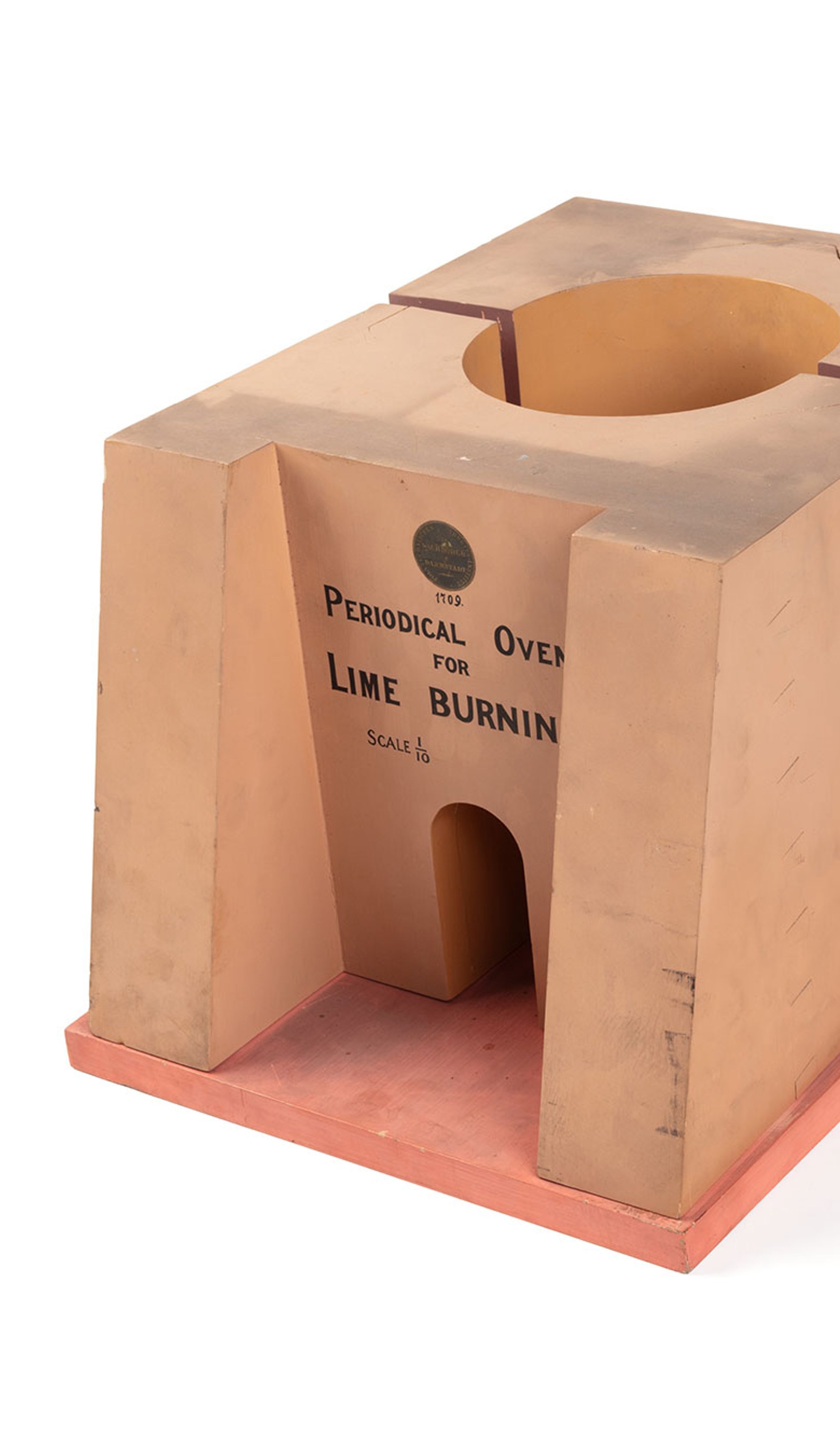 A model of a lime kiln or limestone burning furnace made from timber and metal. The front of the model reads ‘Periodical Oven For Lime Burning. Scale 1/10’.