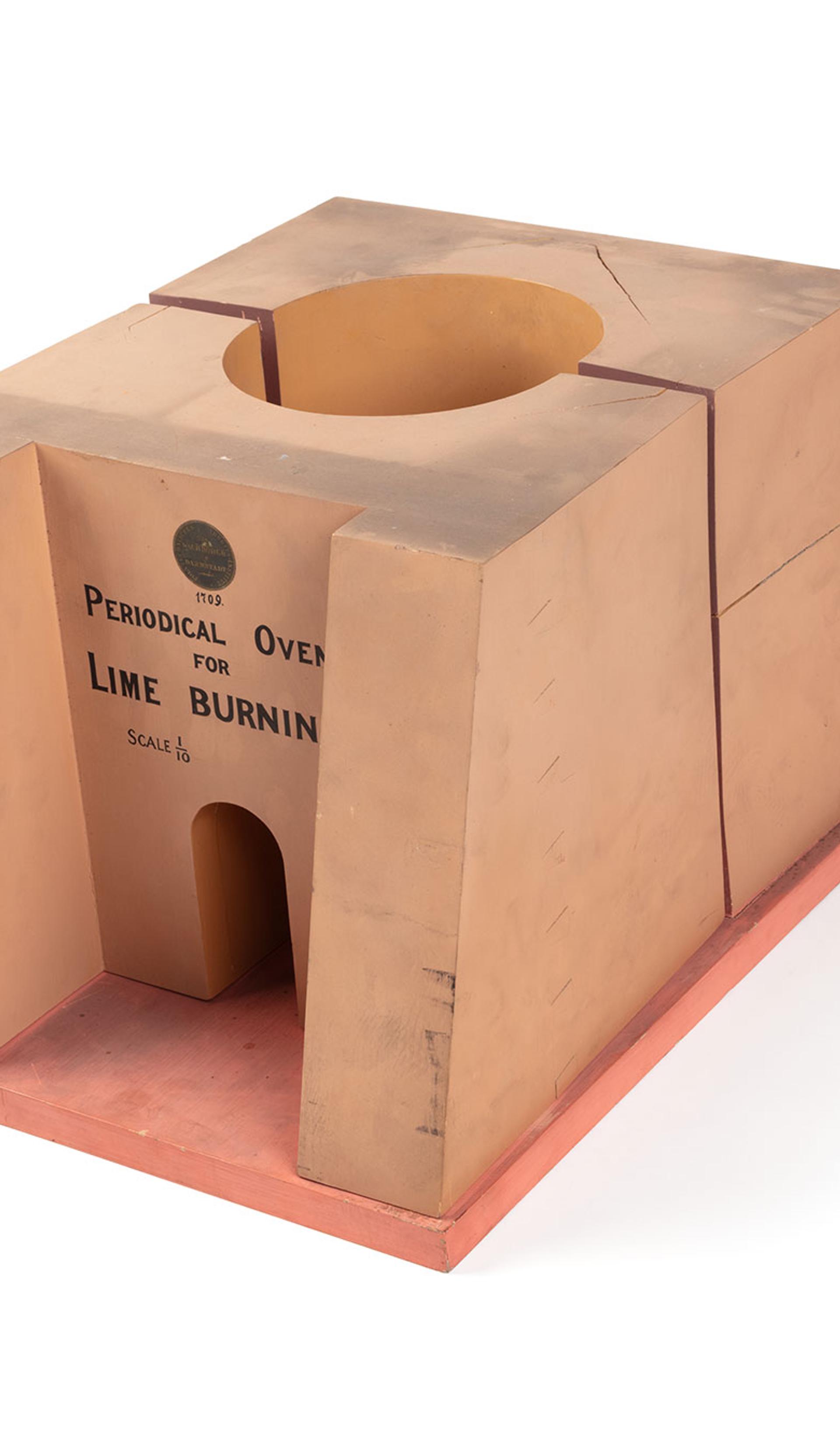 A model of a lime kiln or limestone burning furnace made from timber and metal. The front of the model reads ‘Periodical Oven For Lime Burning. Scale 1/10’.