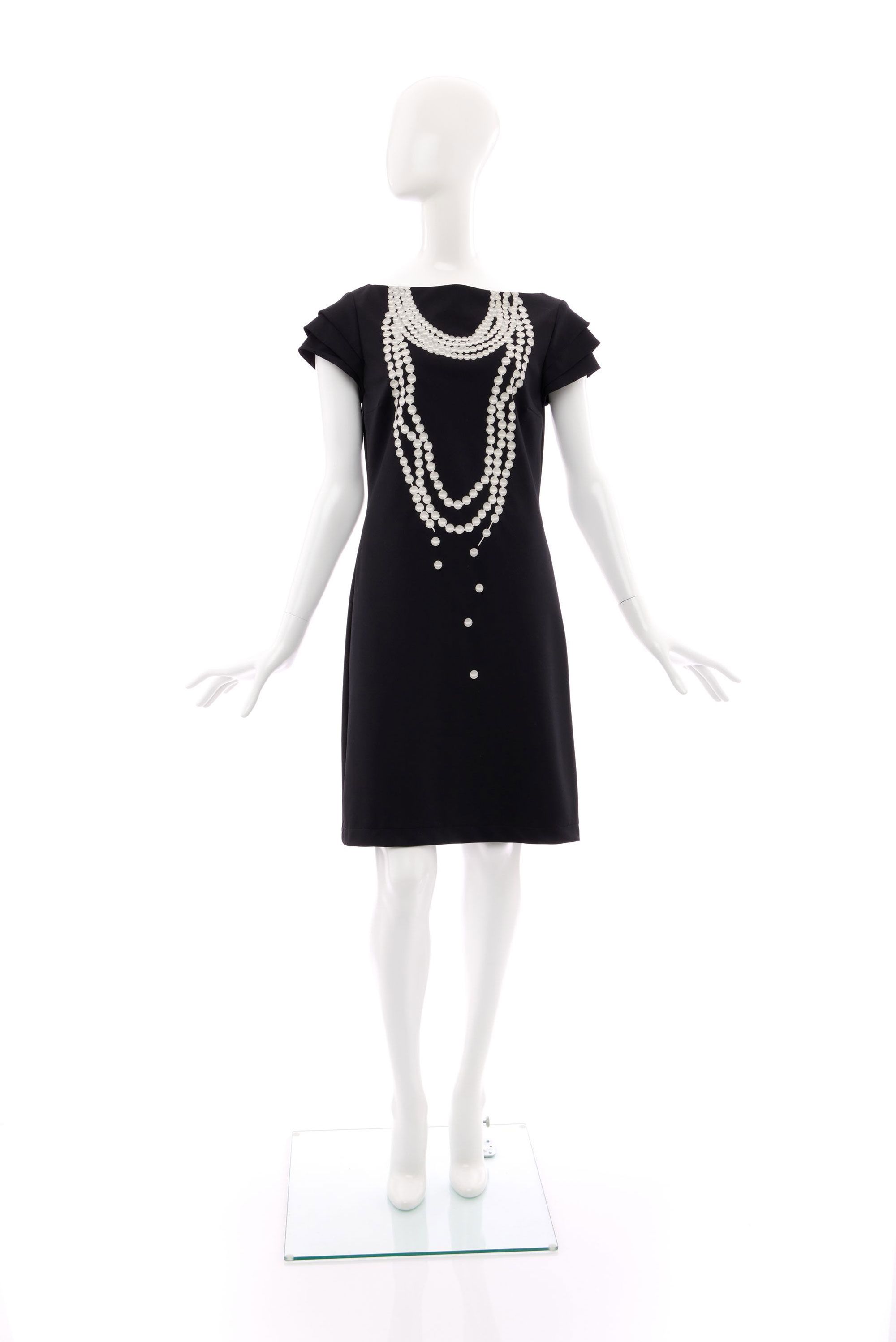 Body hugging, knee length dress made of navy blue cotton mix fabric. Printed in white and grey on the front of the dress is a fake multi-strand necklace of pearls.