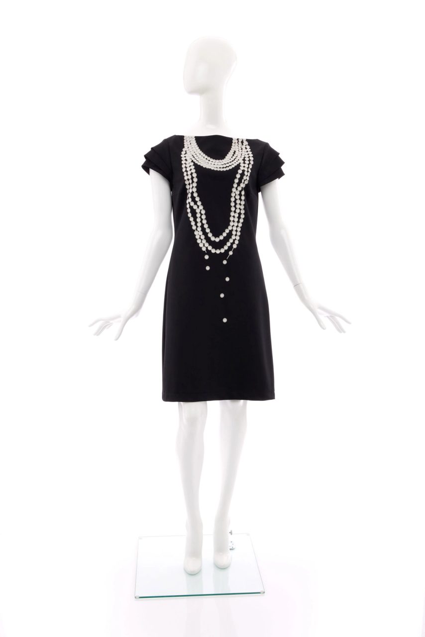 Body hugging, knee length dress made of navy blue cotton mix fabric. Printed in white and grey on the front of the dress is a fake multi-strand necklace of pearls.