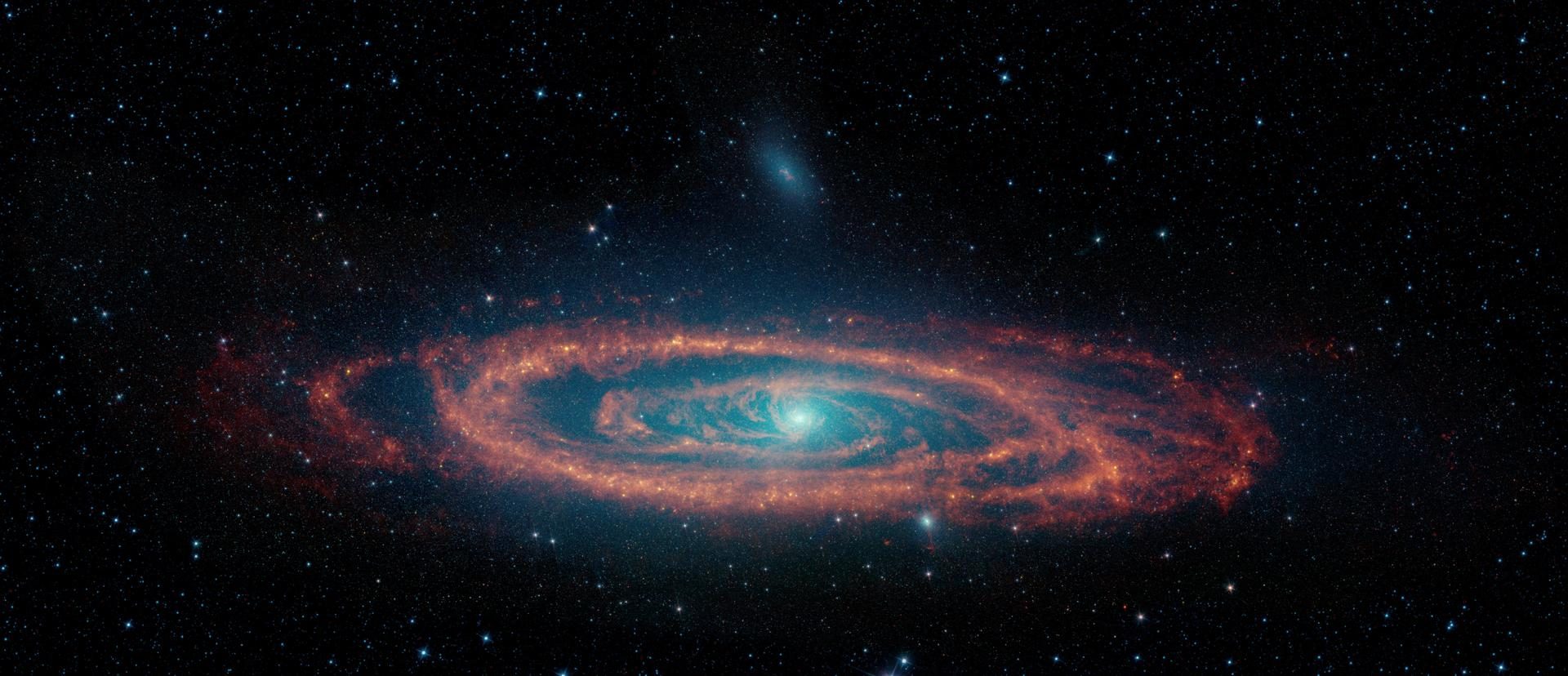 Starlight glows blue and cyan in the centre, with rotating rings of orange surrounding it.
