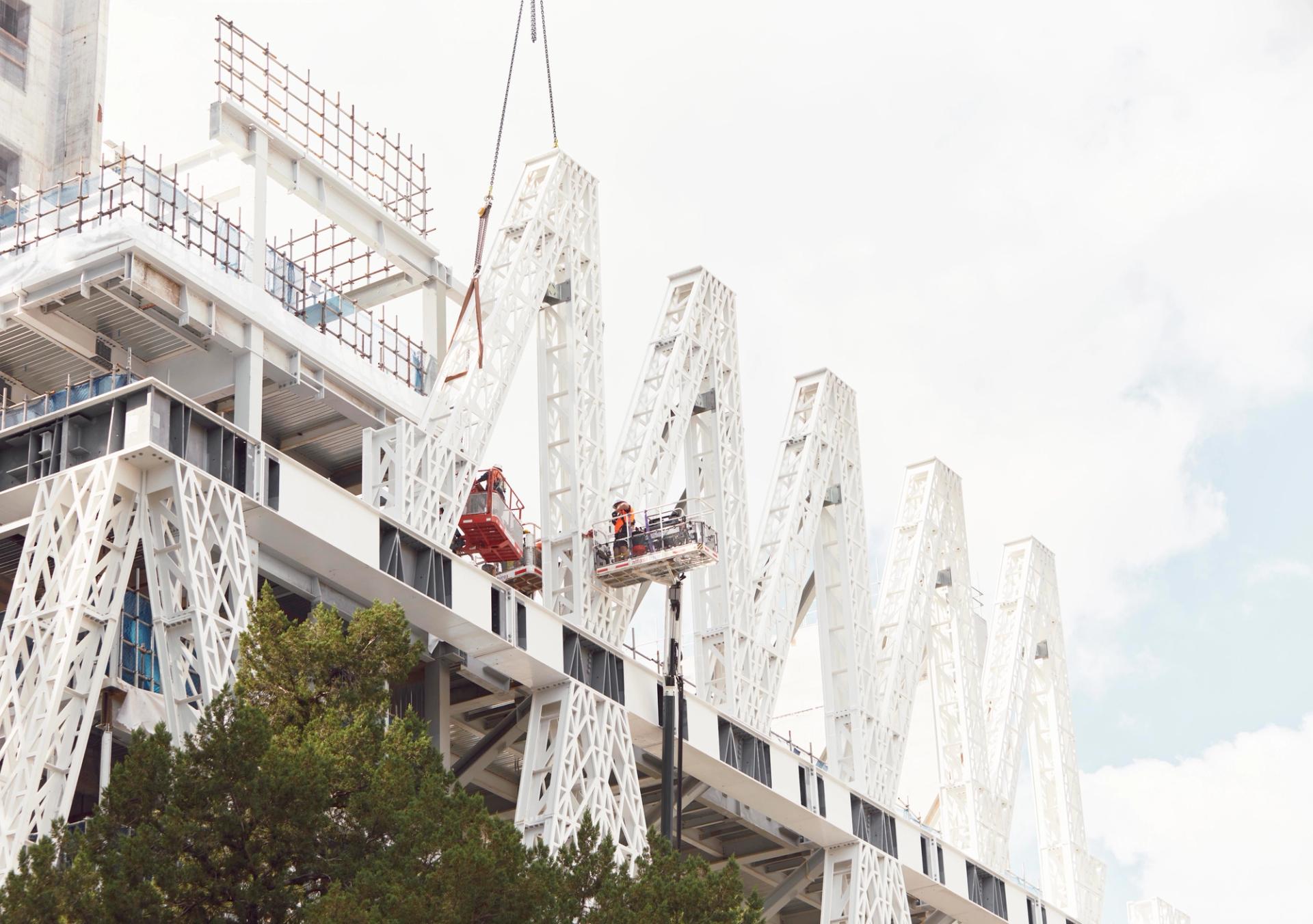 Ground view of building under construction.