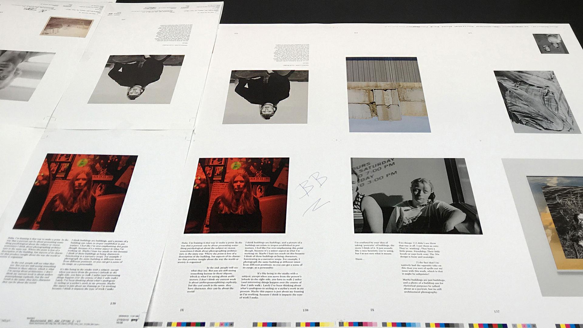 Printed pages lie on the printing press, a mixture of black and white, colour images and text.