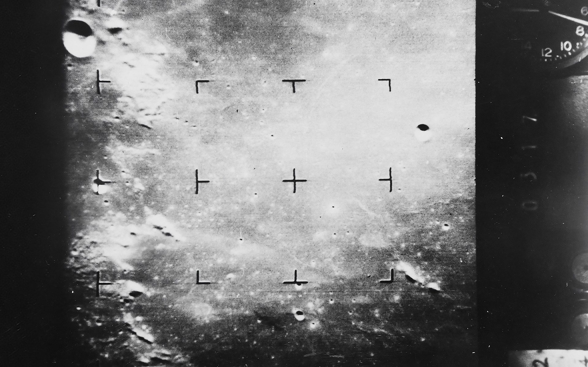 Photograph showing the moon’s surface taken in black and white.