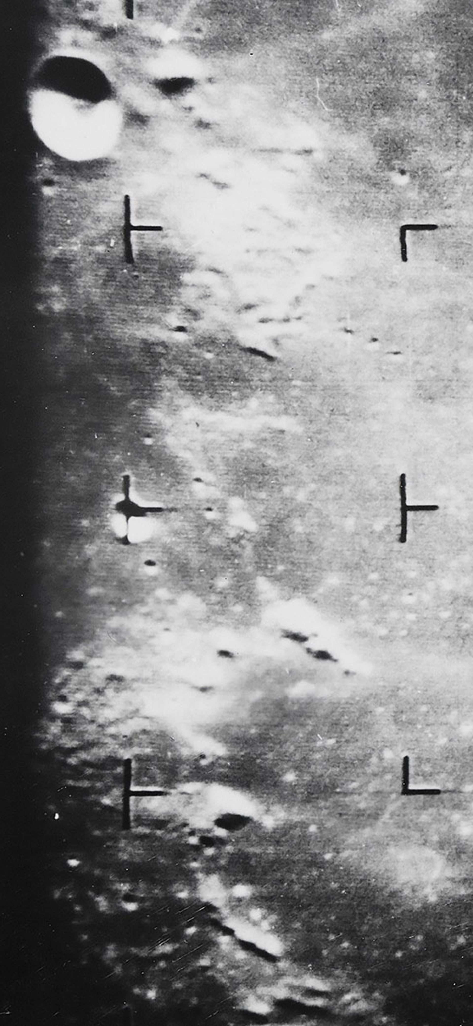 Photograph showing the moon’s surface taken in black and white.
