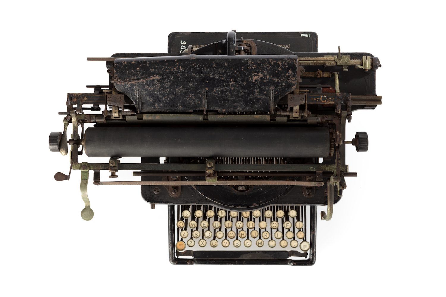 Black typewriter with metal accessories and cream and black keys.