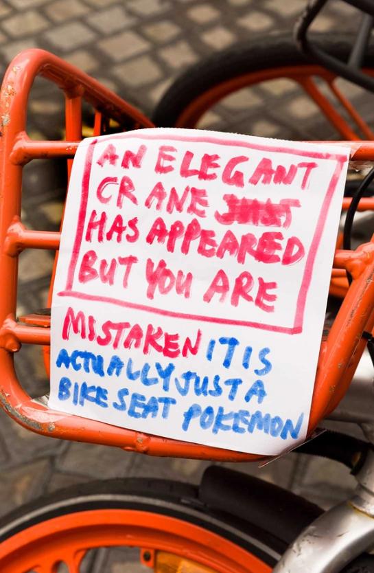 Note reading “AN ELEGANT CRANE HAS APPEARED BUT YOU ARE MISTAKEN IT IS ACTUALLY JUST A BIKE SEAT POKEMON”
