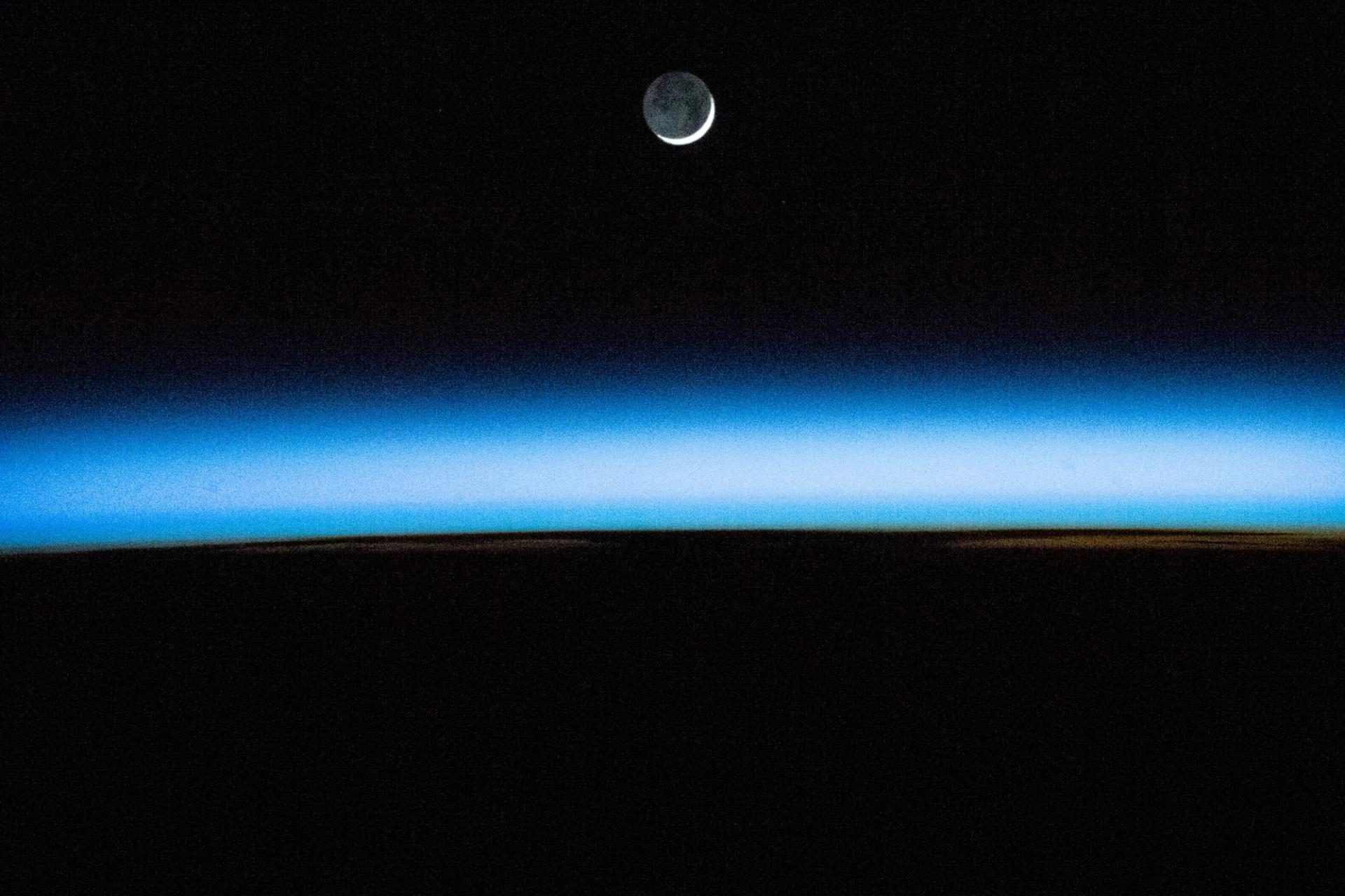 The waxing crescent Moon above Earth's atmosphere