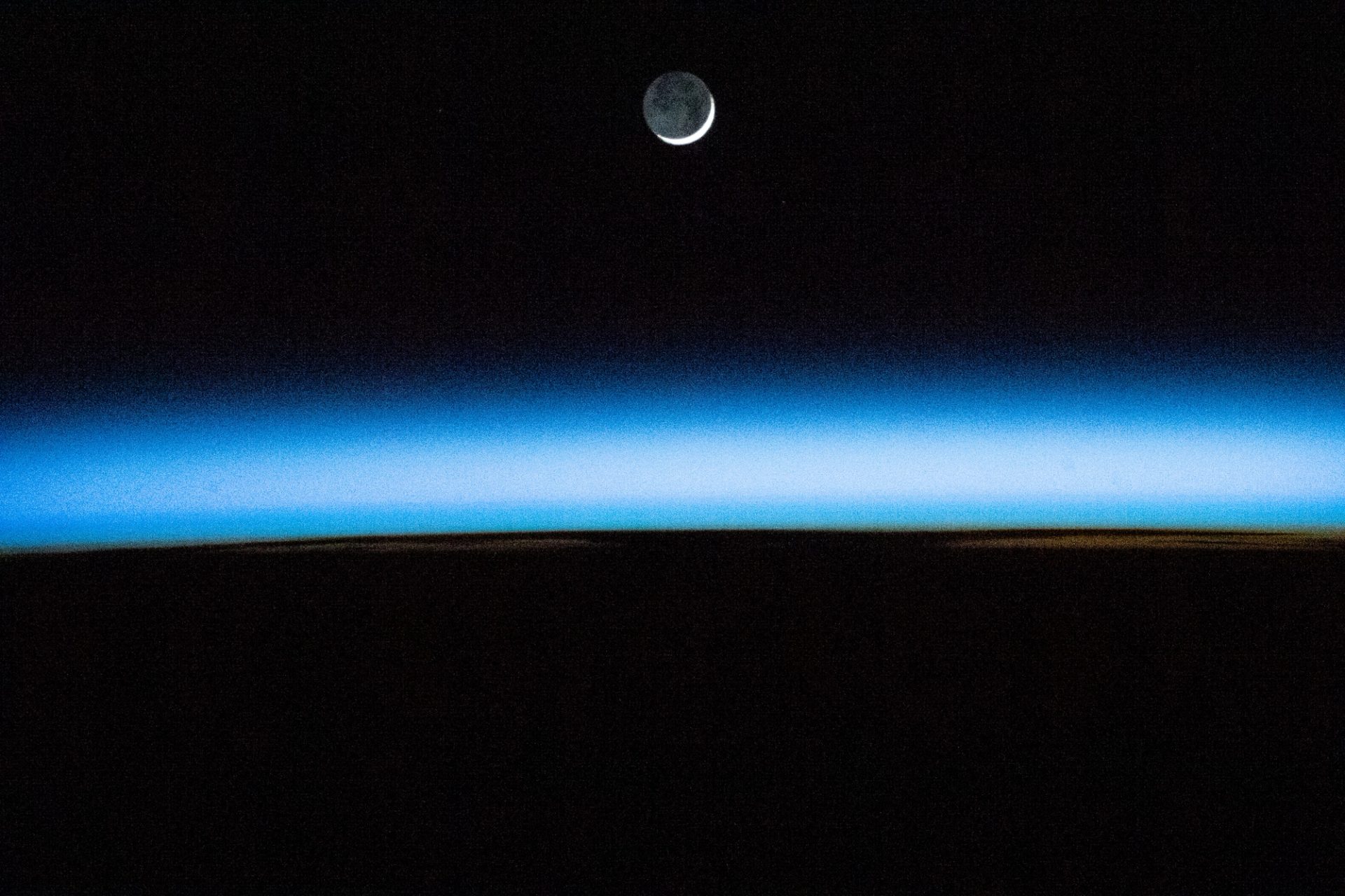 The waxing crescent Moon above Earth's atmosphere