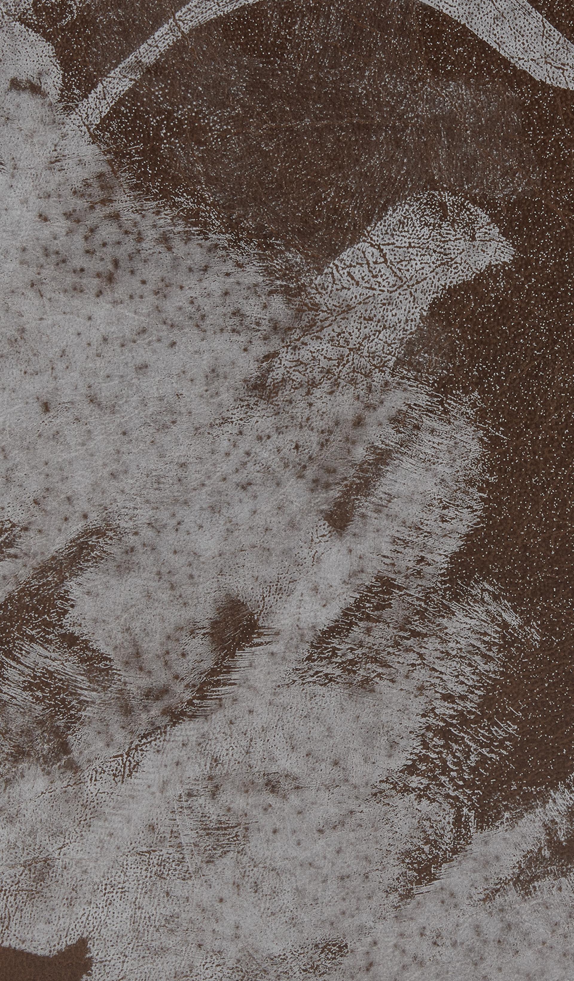 Section of a leather case with white paint stains.