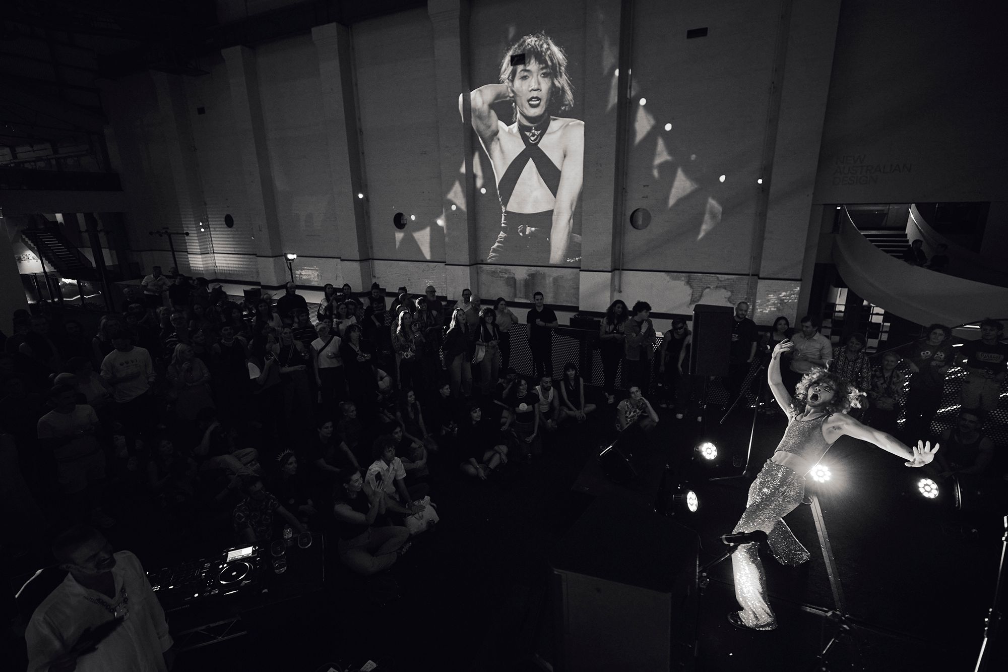 Audience watches performer on stage