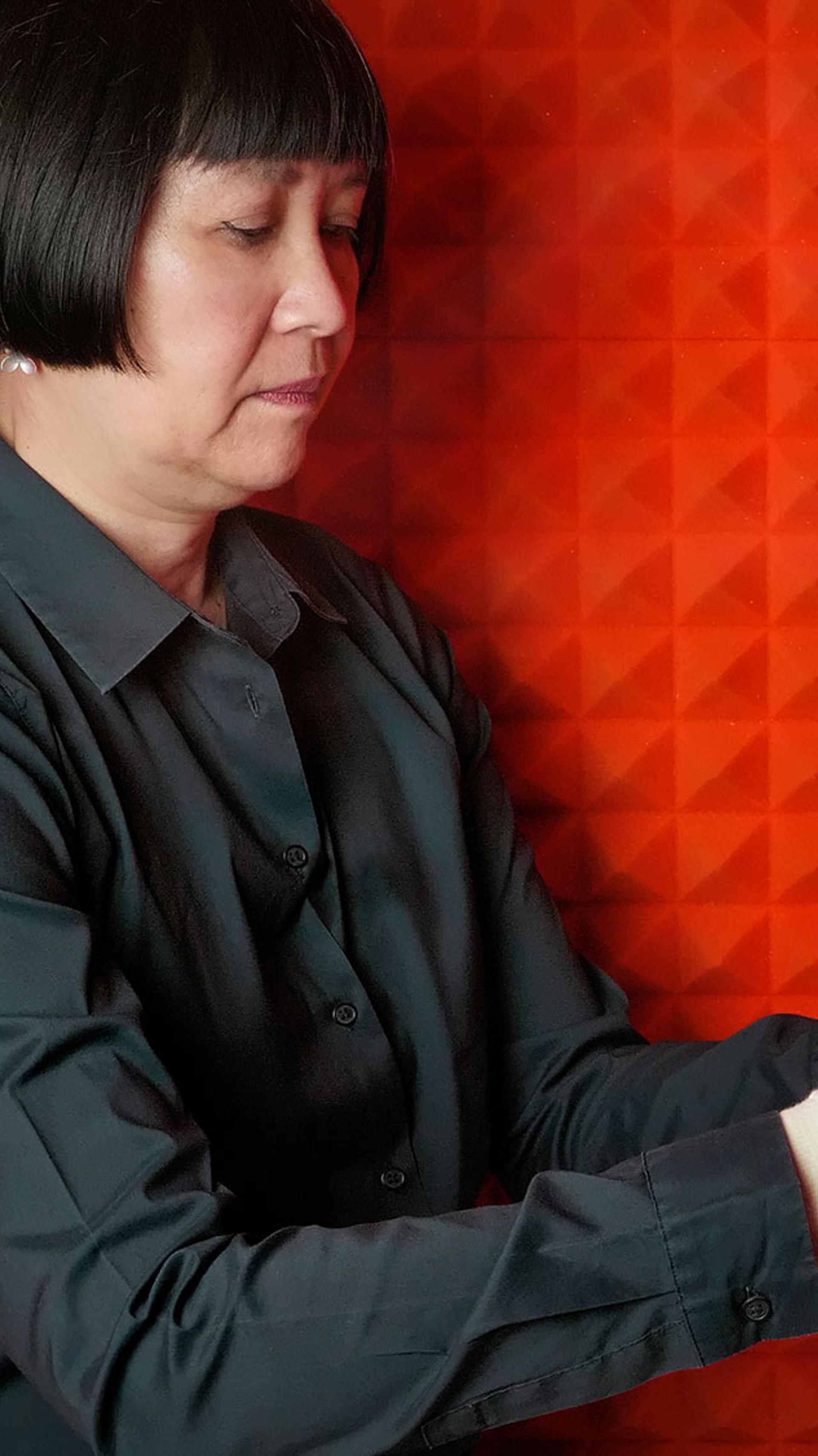 Woman with rubix cube in red recording studio