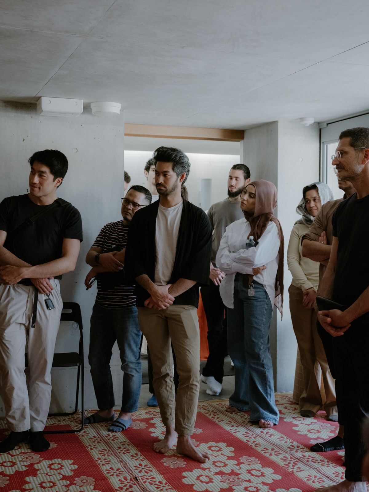 Figures standing and listening to a tour guide