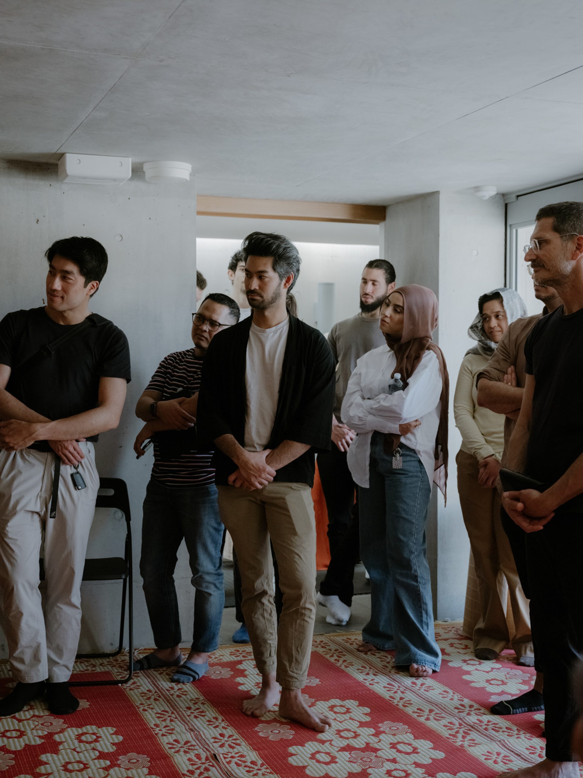 Figures standing and listening to a tour guide